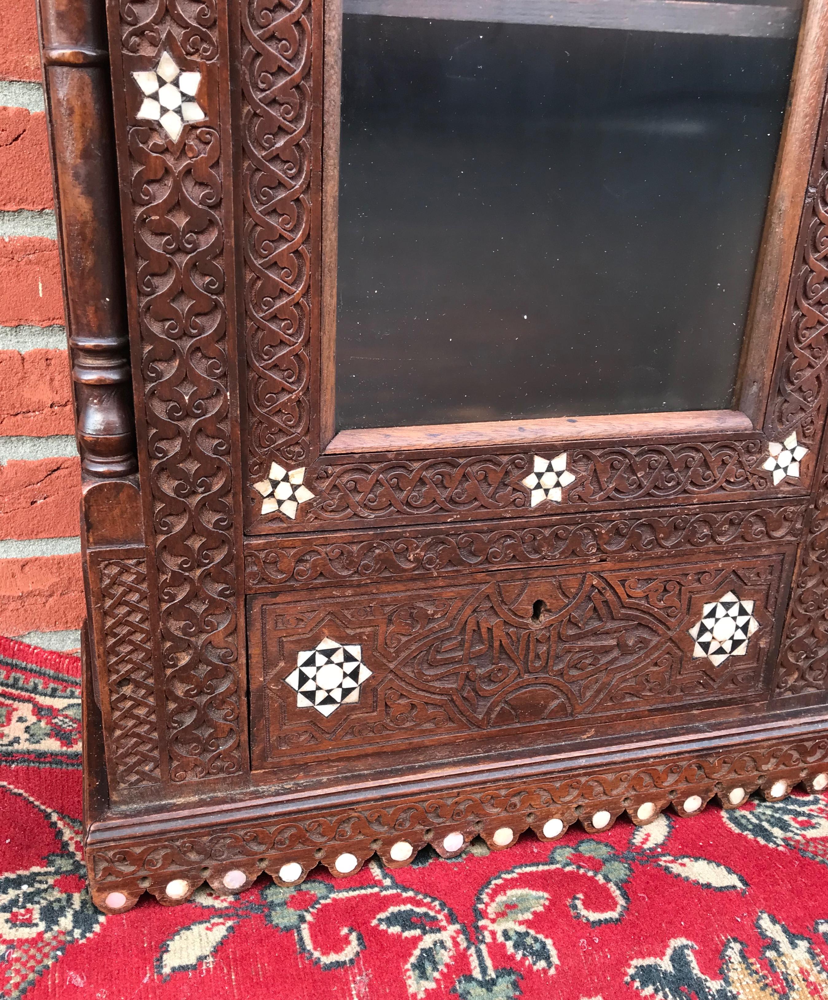 Stylish Antique Eastern Style Wooden Wall Hanging Cabinet with Intricate Details For Sale 8