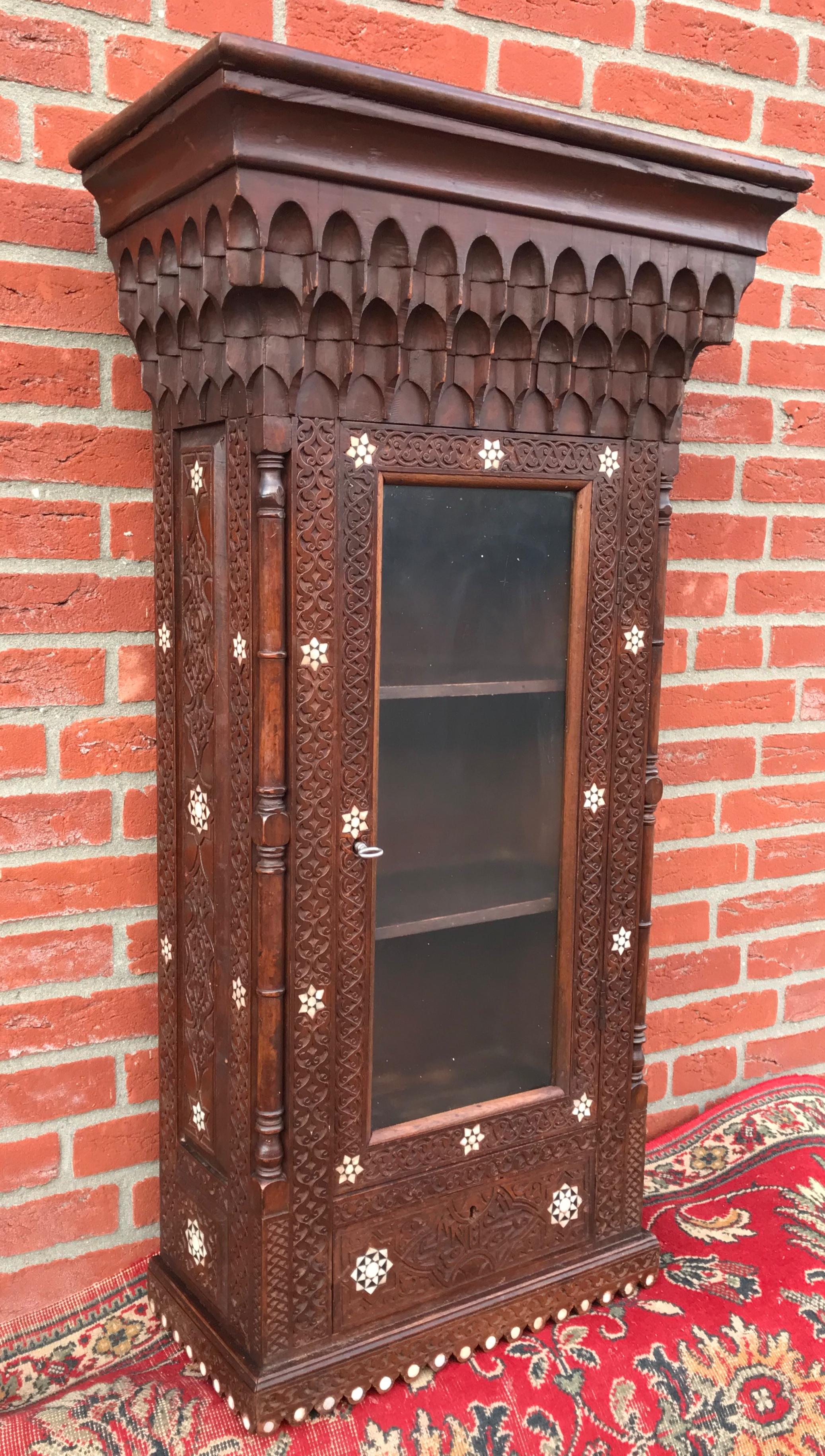 Stylish Antique Eastern Style Wooden Wall Hanging Cabinet with Intricate Details For Sale 12