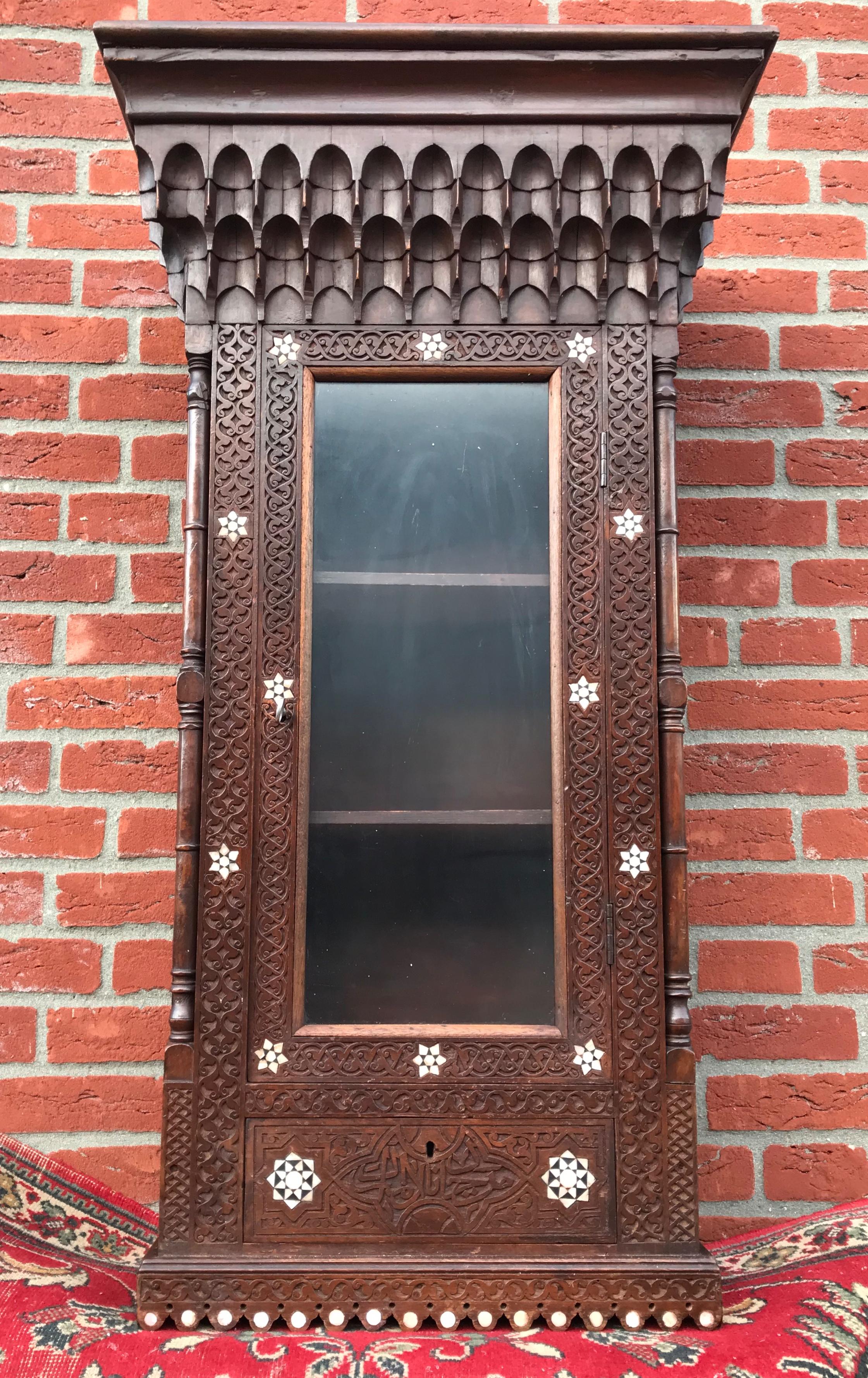 Spanish Colonial Stylish Antique Eastern Style Wooden Wall Hanging Cabinet with Intricate Details For Sale