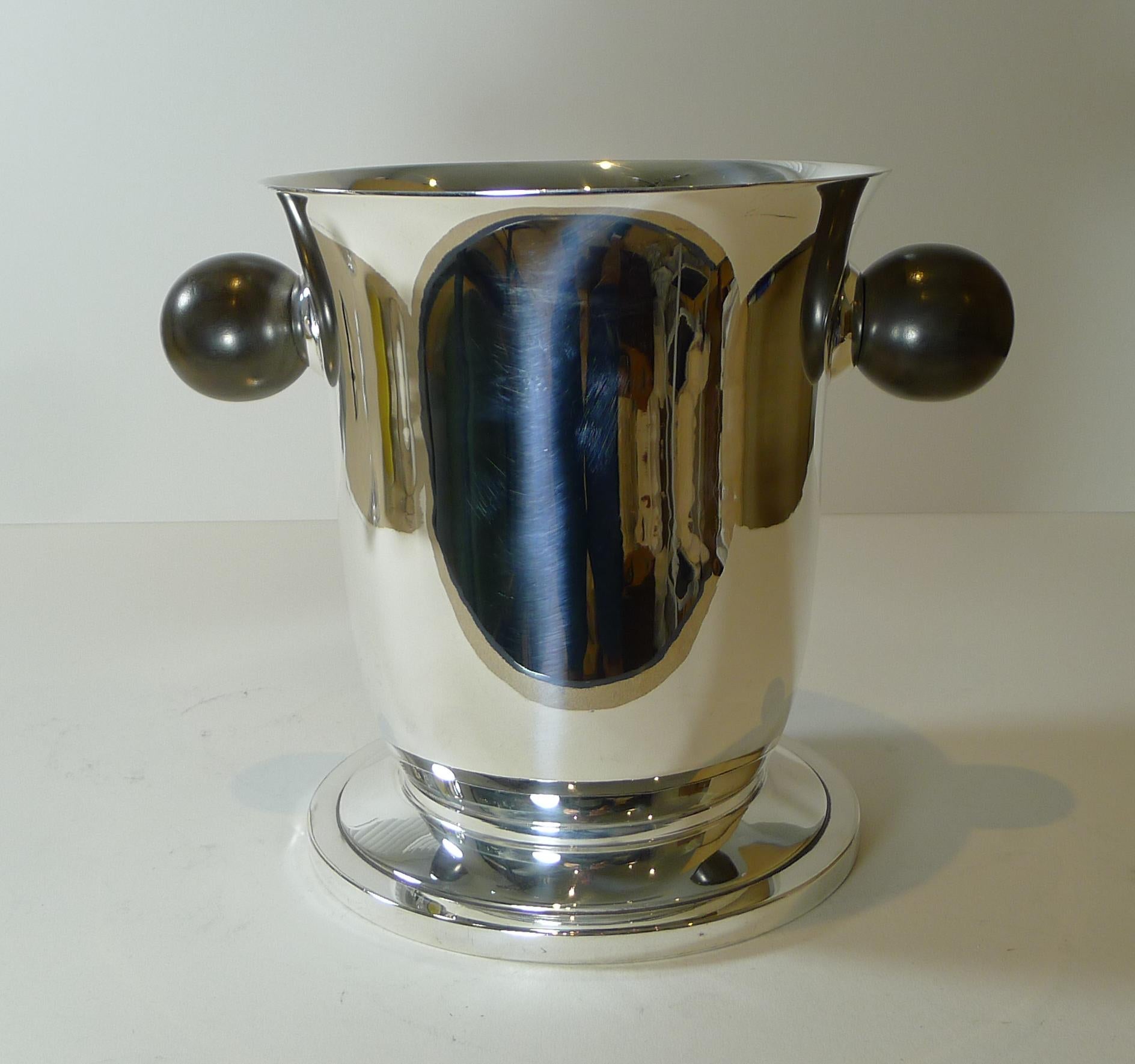 A stunning and stylish antique French champagne bucket or wine cooler in silver plate with stunning turned wooden handles; a great modernist / art deco style but actually made earlier between 1901 and 1906.

The underside is fully marked by the