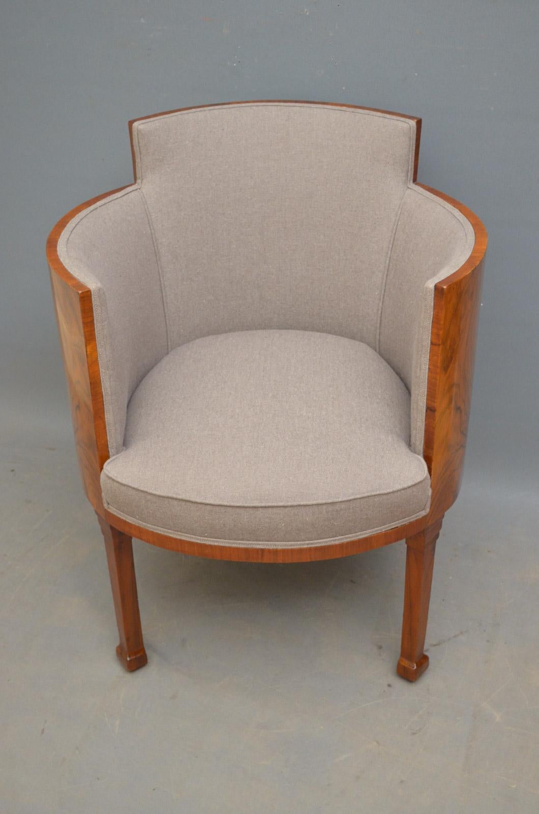 K0135 Unusual and very elegant, walnut Art Deco tub chair, having figured walnut shaped back and arms and stylish contemporary cover in grey, standing on tapered legs with stepped decoration. This antique armchair has been sympathetically restored