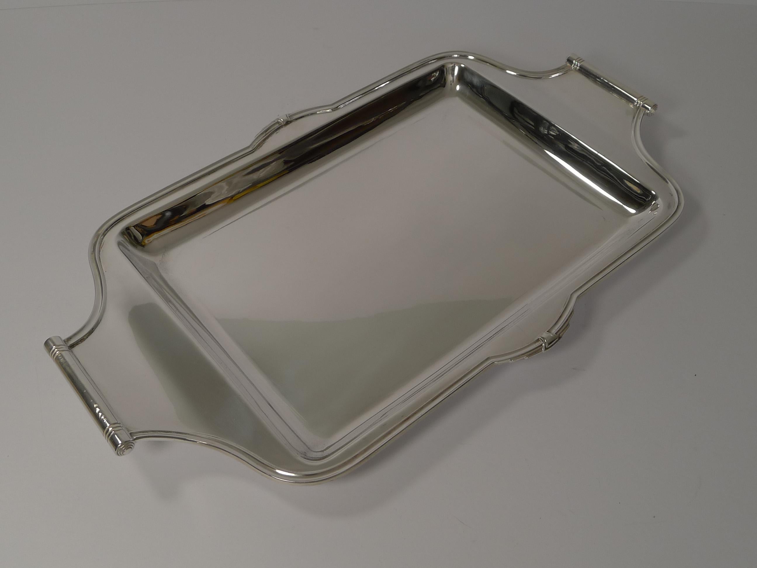 About as stylish as they get, this is stunning shaped cocktail tray with beautiful Art Deco detailing including beautiful handles.

Just back from our silversmith's workshop where any dents were removed and restored to it's former glory.

The