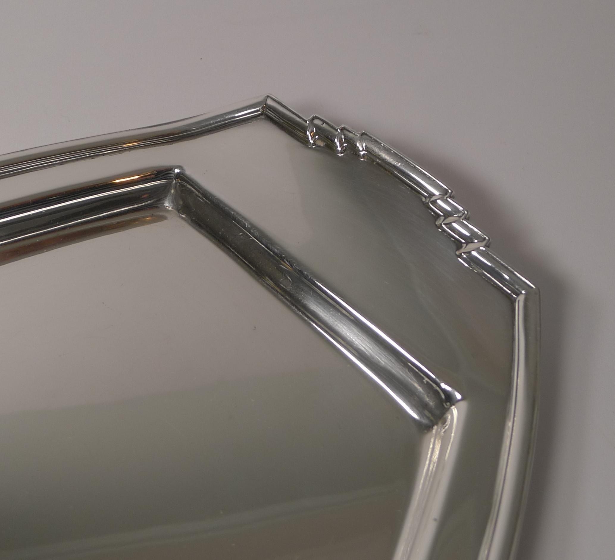 A very stylish Art Deco cocktail tray with a geometrical decoration to all four sides.

Made from silver plate, the underside is lucky enough to have an English design registration number which allows us to date it to 1933. It is signed by the