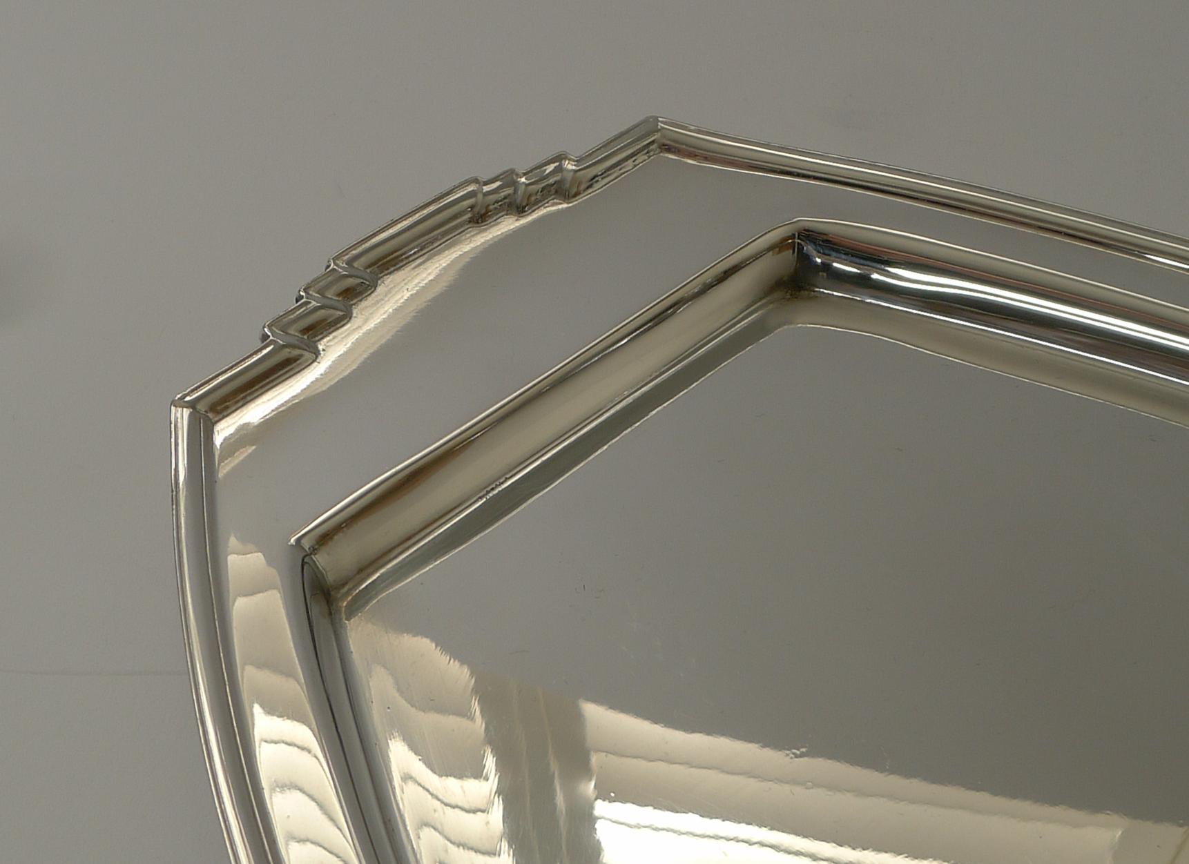 A very stylish Art Deco cocktail tray with a geometrical decoration to all four sides.

Made from silver plate, the underside is lucky enough to have an English design registration number which allows us to date it to 1933. It is signed by the