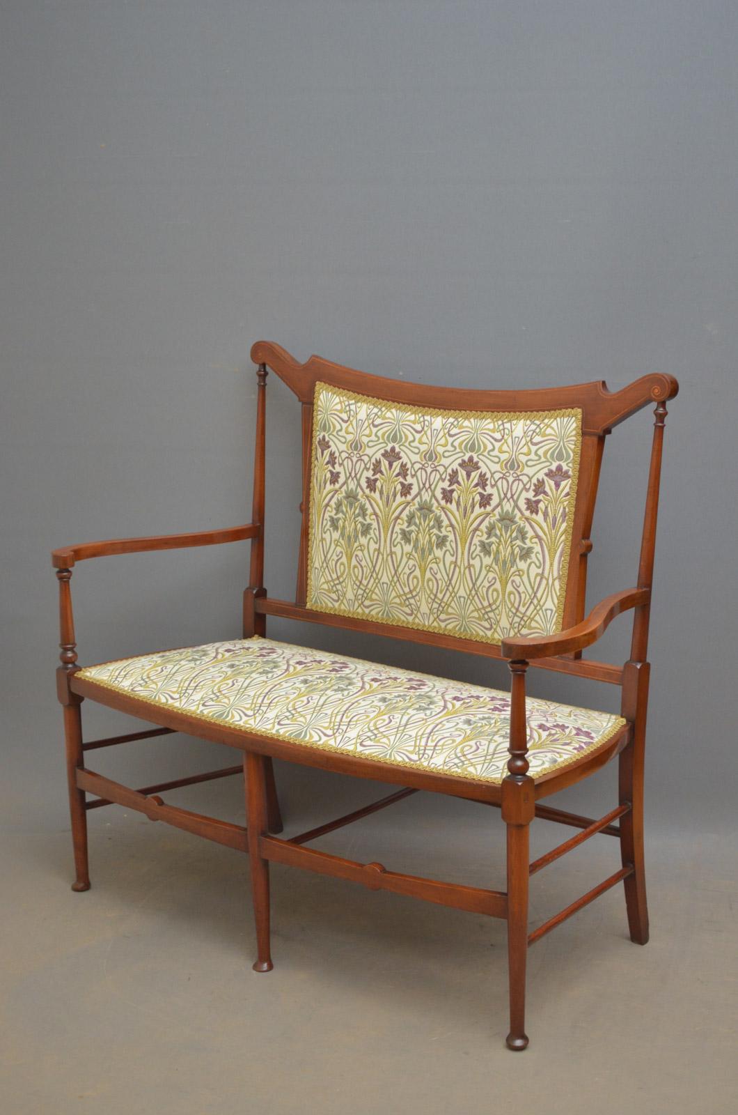 Sn4428, stylish Art Nouveau sofa, having shaped and inlaid top rail and, open arms and upholstered back and seat, covered in William Morris style fabric, standing on slender, turned legs and pad feet. This antique settee has been sympathetically