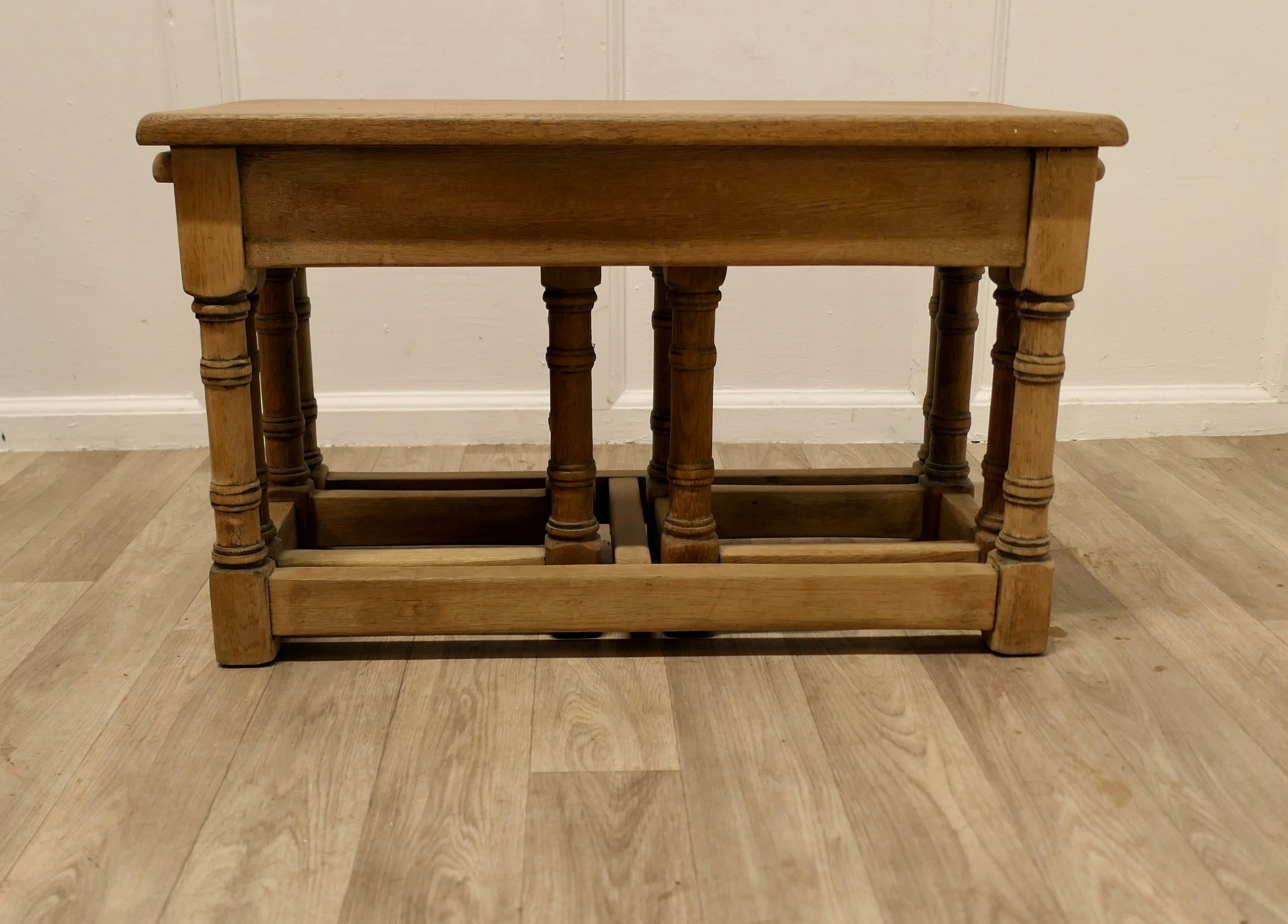Stylish Arts and Crafts Nest Of Oak Tables

This is a Good-looking set and beautifully designed, a long coffee table and 2 small occasional tables which slide in at each end , a clever and practical design, all the tables are in good condition 
The