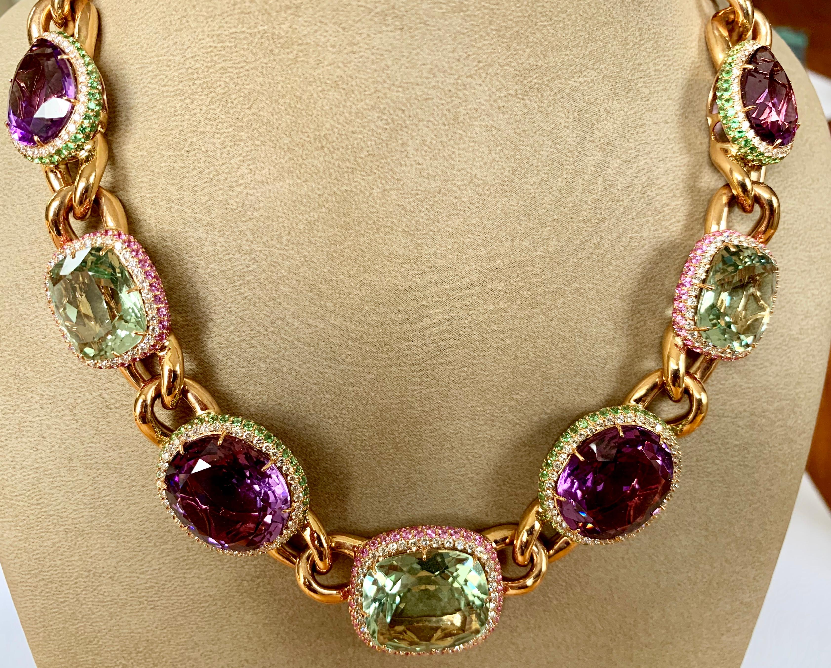 Statement necklace in 18 Karat rose gold, set with 4 Amethysts weighing 68,26 ct. All 4 Amethysts are surrounded by Diamonds and Tsavorites. 3 Prasiolites weighing 51,01 ct of wich each is surrounded by pink Sapphires and Tsavorites. 
Total 208 pink