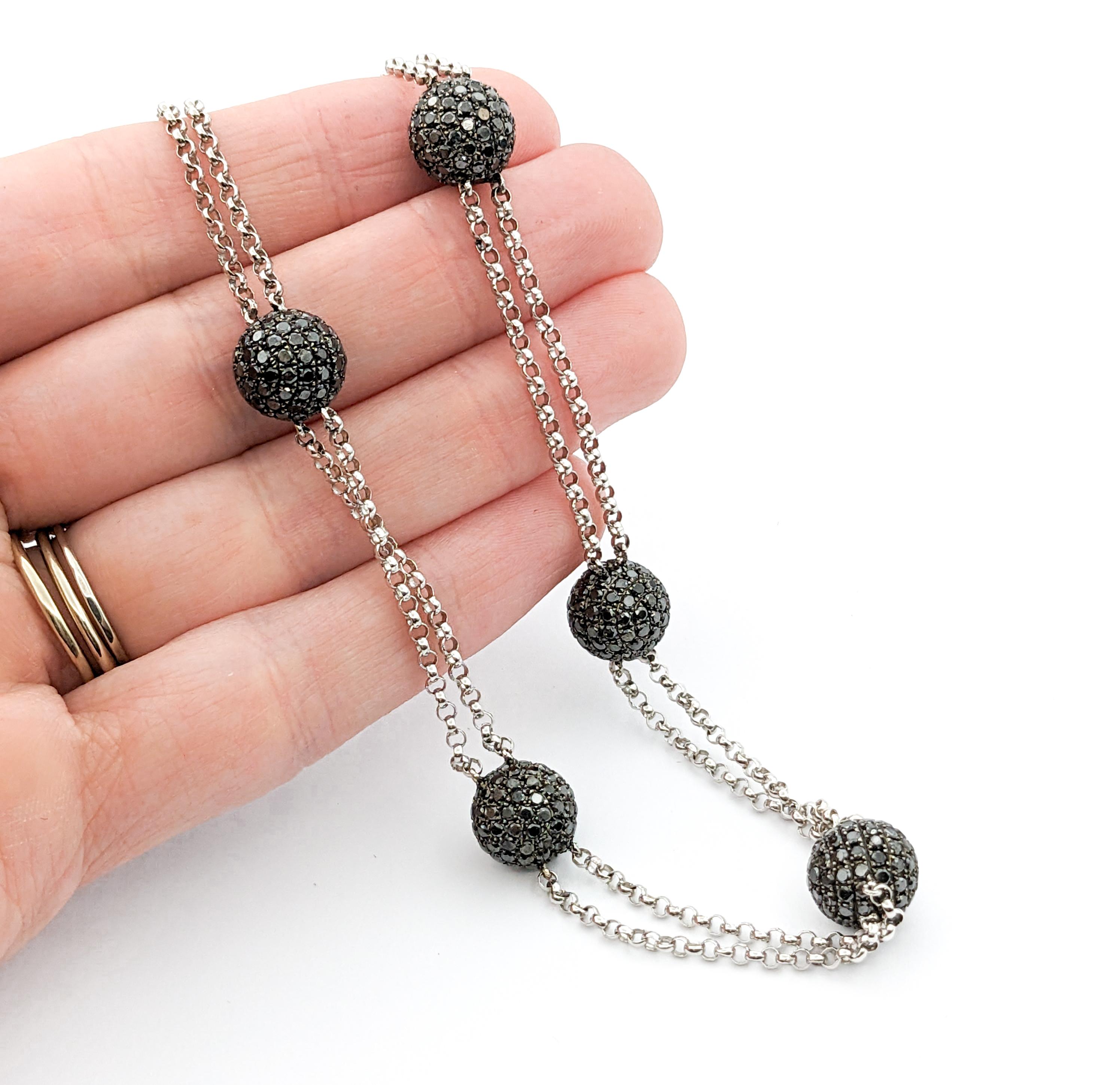 Stylish Black Diamond Station Necklace - 18K White Gold

This fabulous necklace is crafted in 18kt white gold and features 12.50ctw round-cut black diamonds. This necklace is adjustable and measures 18 - 20 inches in length; total weight is