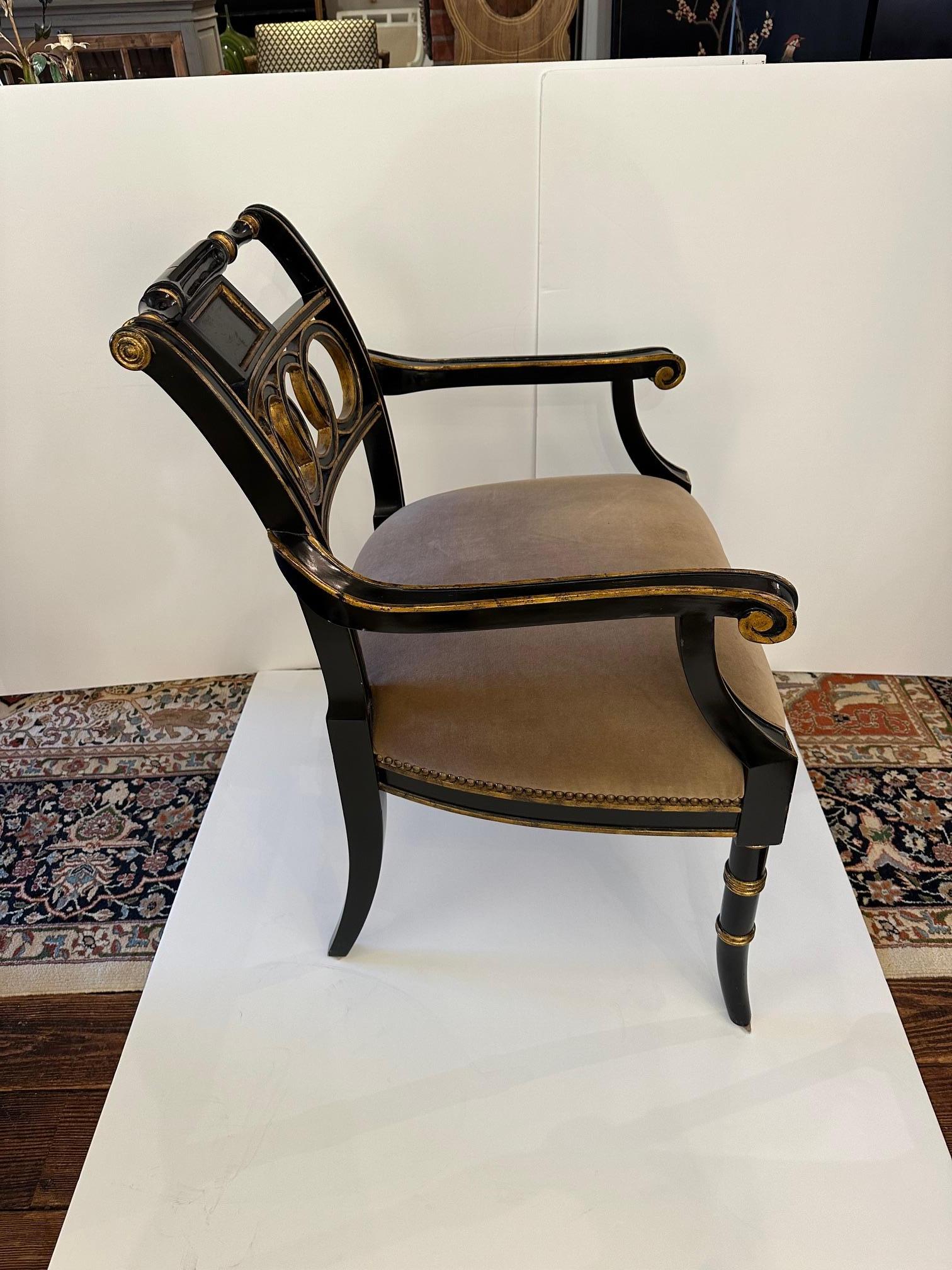 Glamorous Hollywood Regency style armchair in black and gold with elegant taupe velvet seat.  

Arm. 26.5” H
Seat.  19” D x 19” H