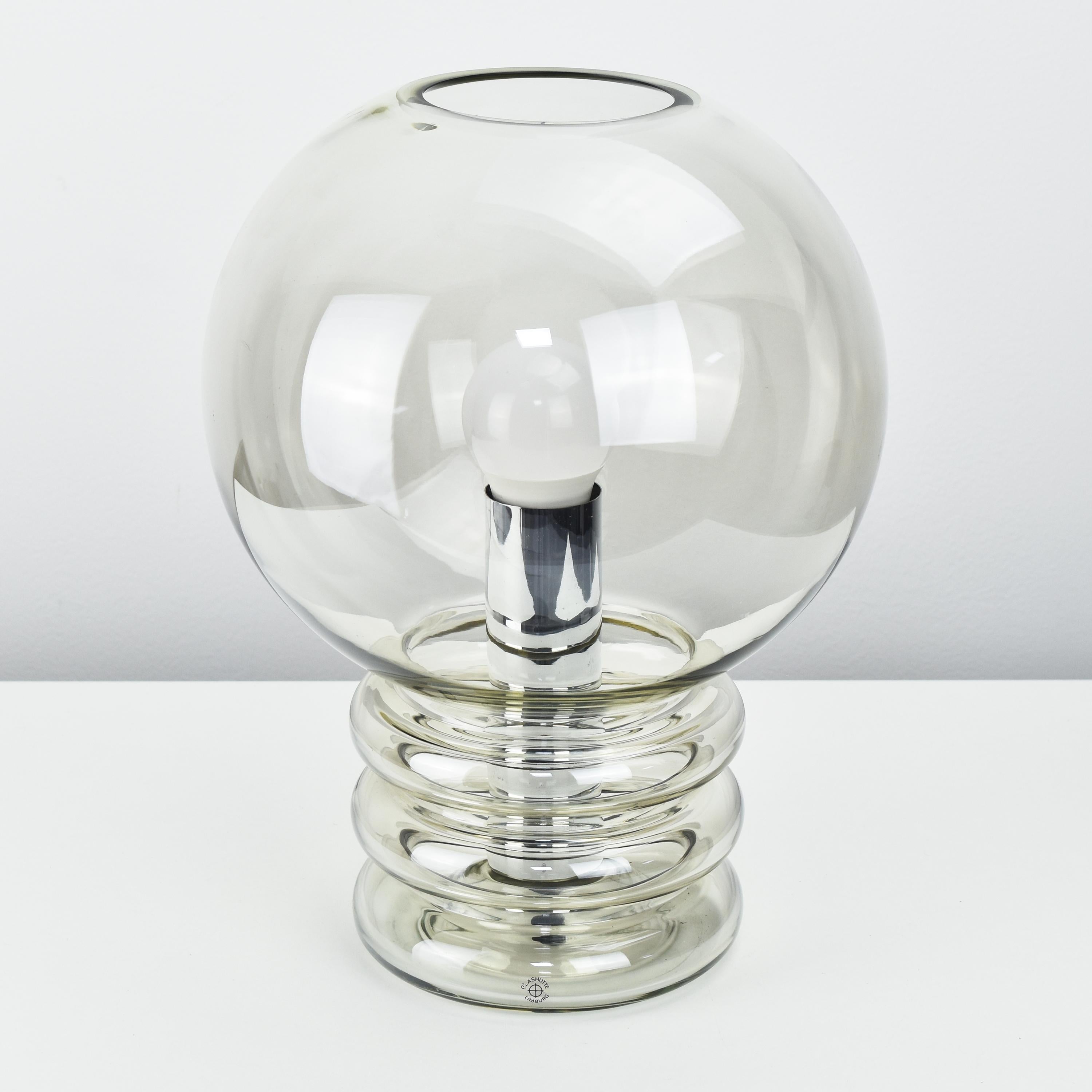 A stunning handmade table lamp designed in the shape of a light bulb designed by Herbert Proft for Glashütte Limburg in the 1970s. The lamp is made from a single piece of clear, hand blown glass and has an E27 light bulb socket.