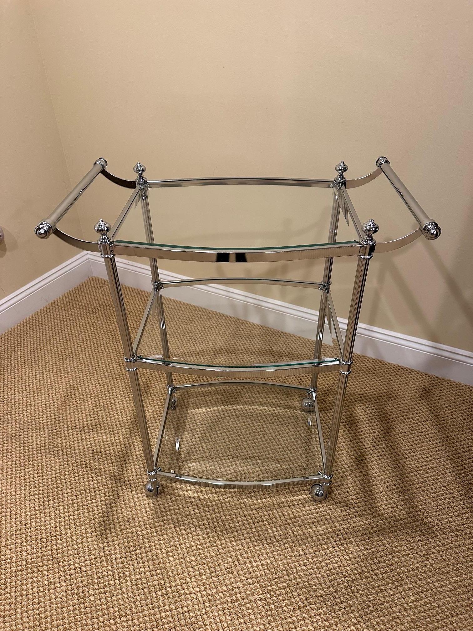 Functional and stylish well made chrome and glass bar cart having 3 tiers and on casters. 

Seip