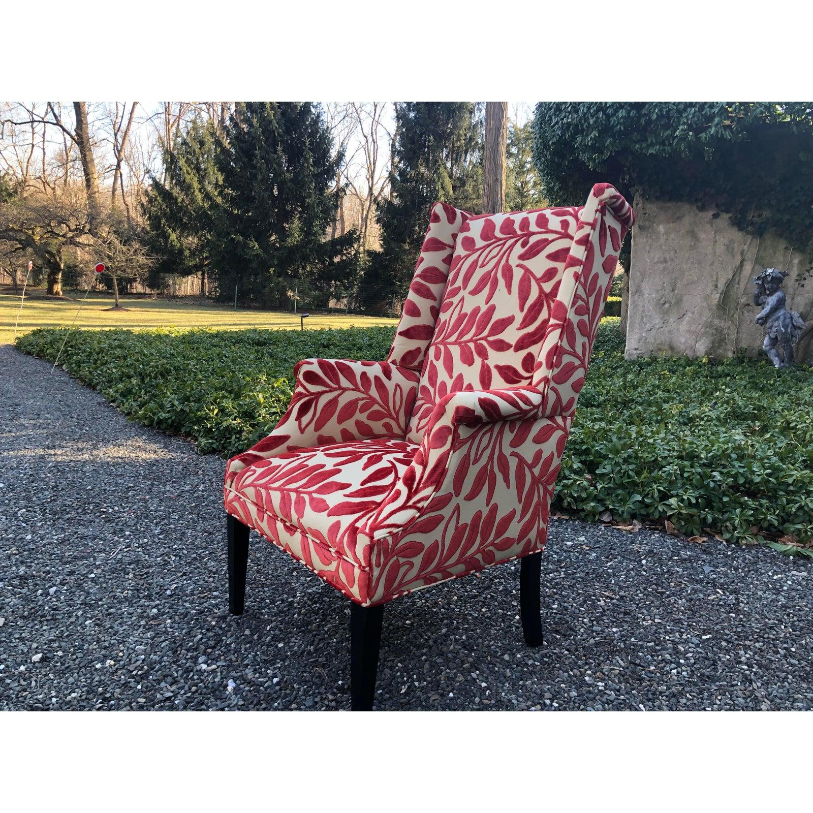 A modernist take on the Classic wing chair having new updated upholstery in a stylish fabric with beige background and graphic raised velvet leaves in a deep coral color. Simple straight ebonized legs.