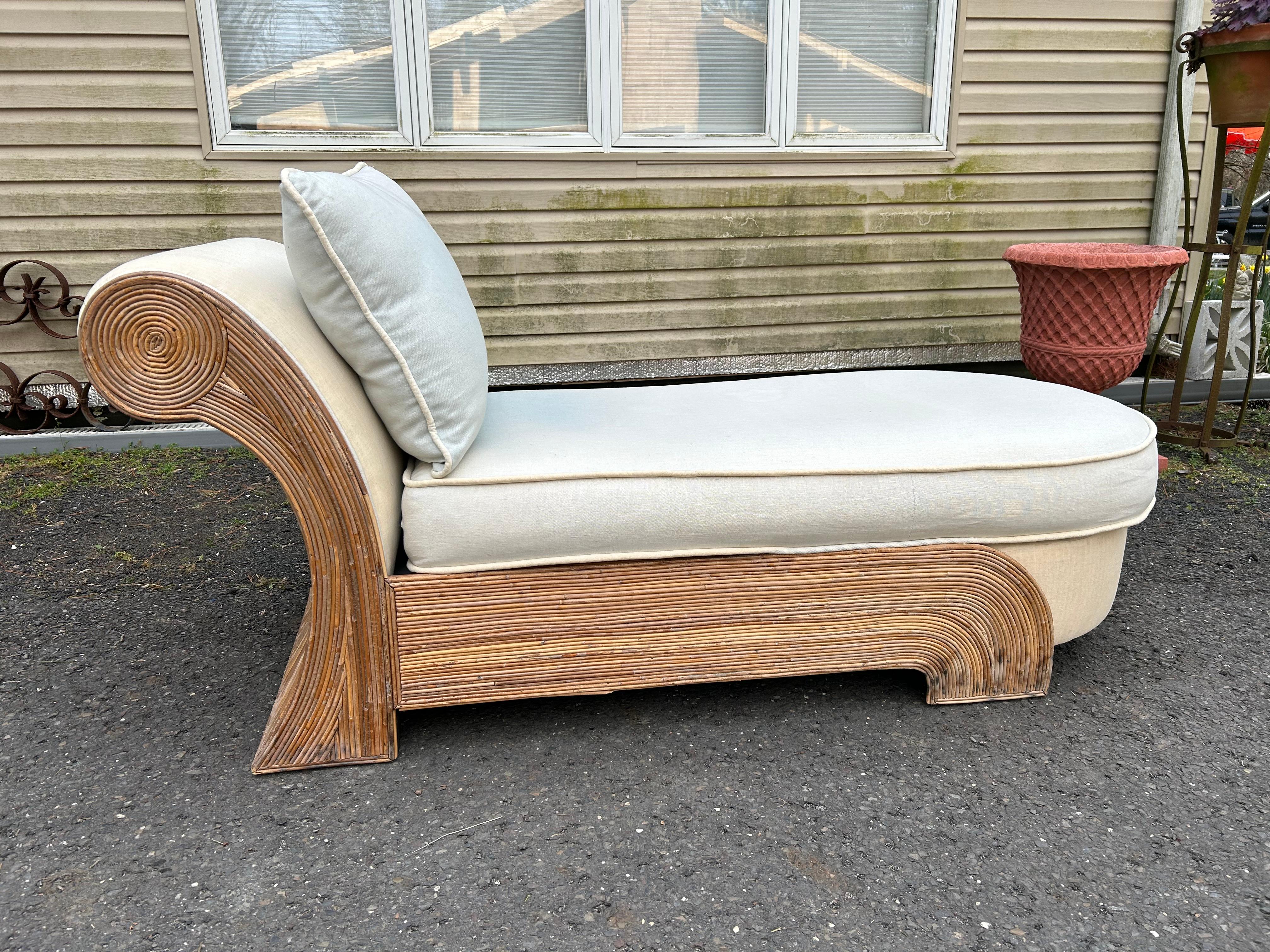 A fantastic vintage Coastal chaise lounge made by the iconic Comfort Designs. A chic pencil reed frame in a fab scroll design and upholstered in a light blue linen.  This piece measures 28't x 67