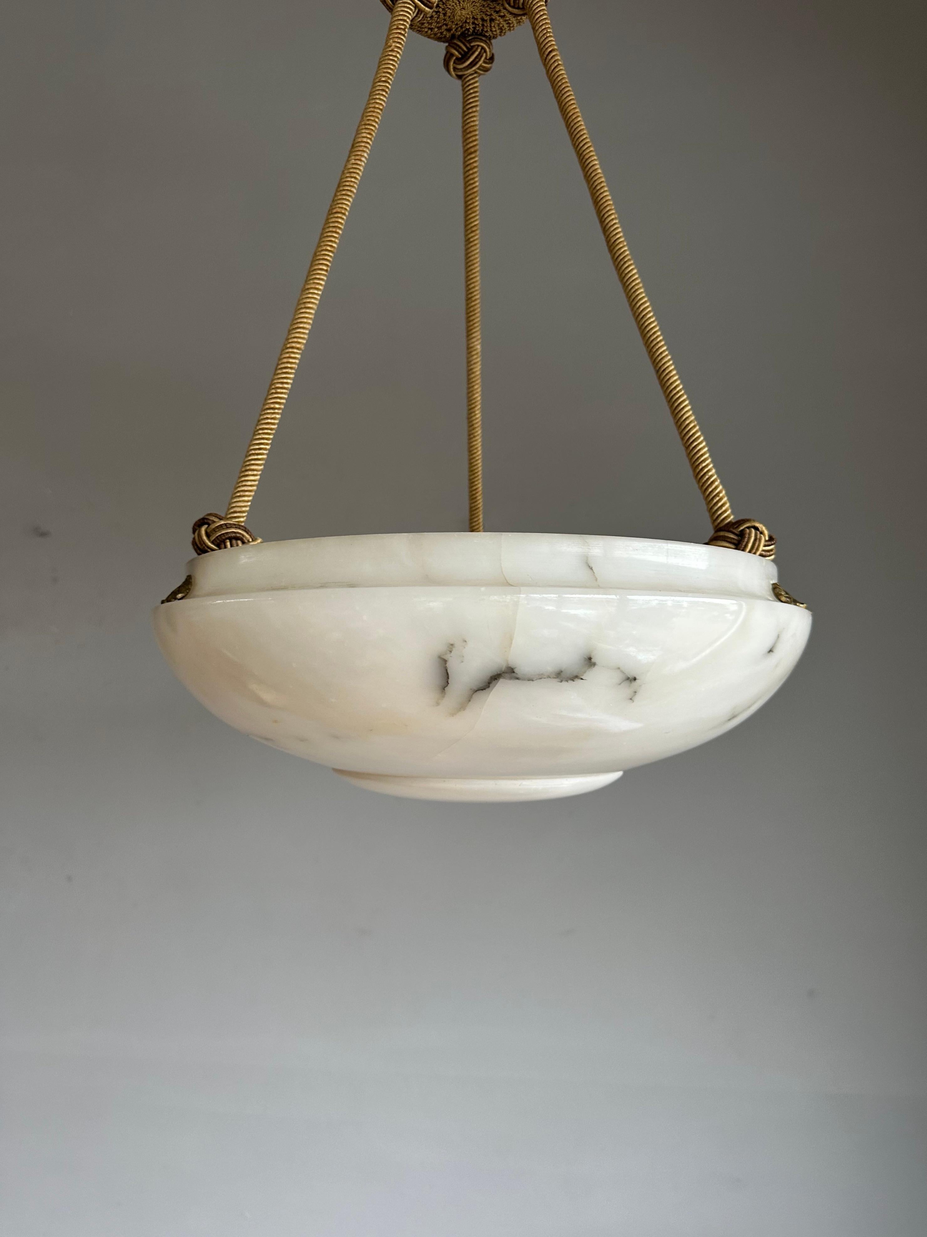 Good size and great design, hand carved, antique alabaster chandelier.

Thanks to its layered yet calm Art Deco design this timeless alabaster chandelier will look great in all kinds of interiors. Apart from one minor imperfection one could not wish