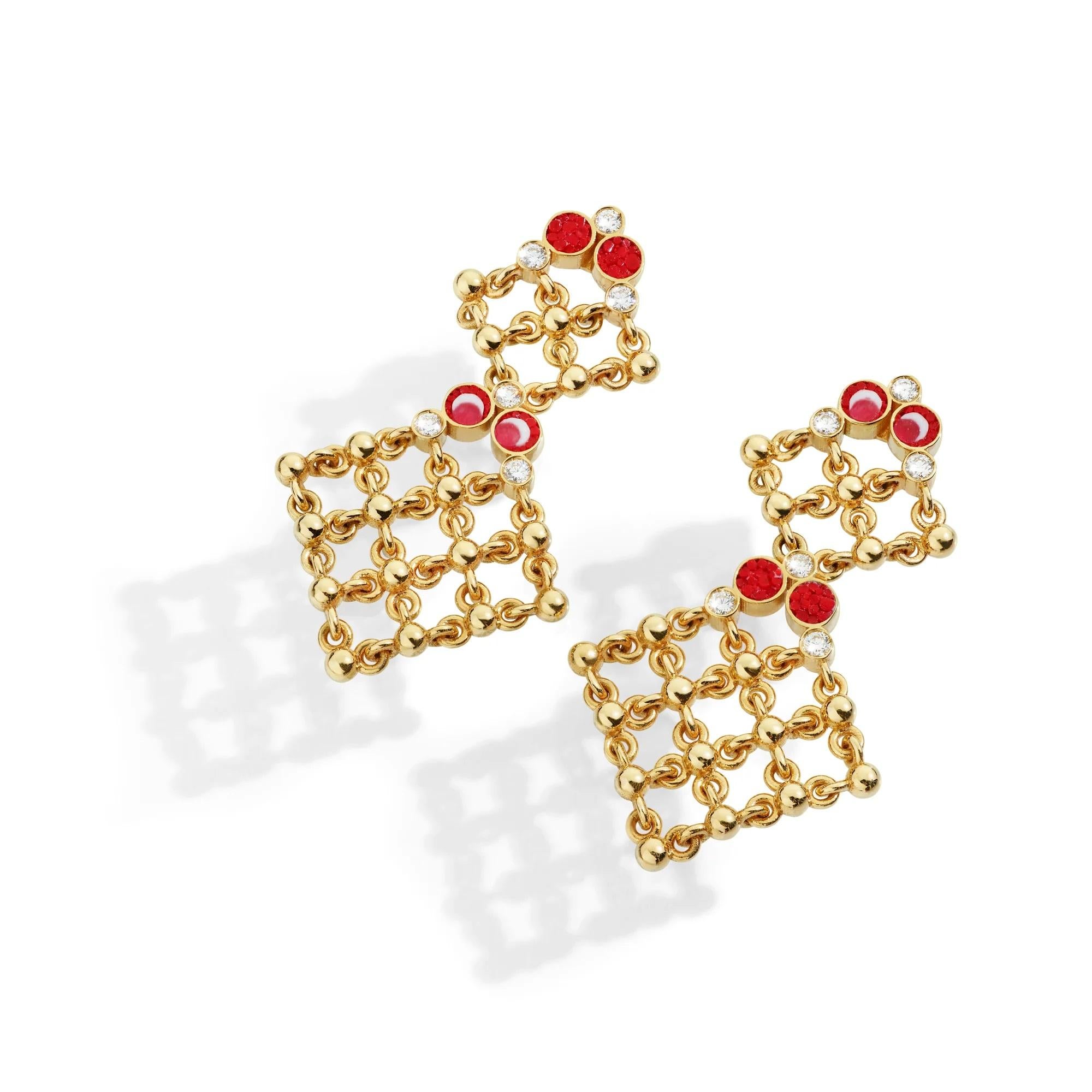 The Tela earrings showcase a refined interplay of gold filigree and vibrant red micromosaic, elegantly arranged in a cascading diamond-shaped design. 
Accentuated by sparkling diamonds, their lace-like structure exudes sophistication, making them a