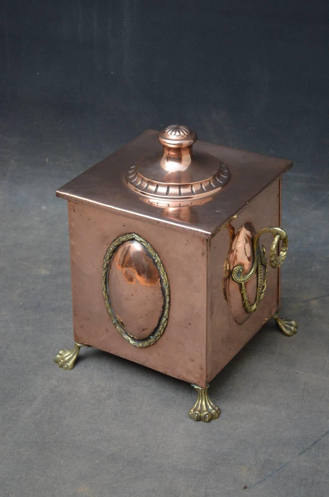 K0313, a stylish Edwardian copper and brass coal bucket / coal scuttle, having lift up lid with embossed handle and elegant decoration to front flanked by superb carrying handles, all standing on original paw feet. This Edwardian coal bucket is in