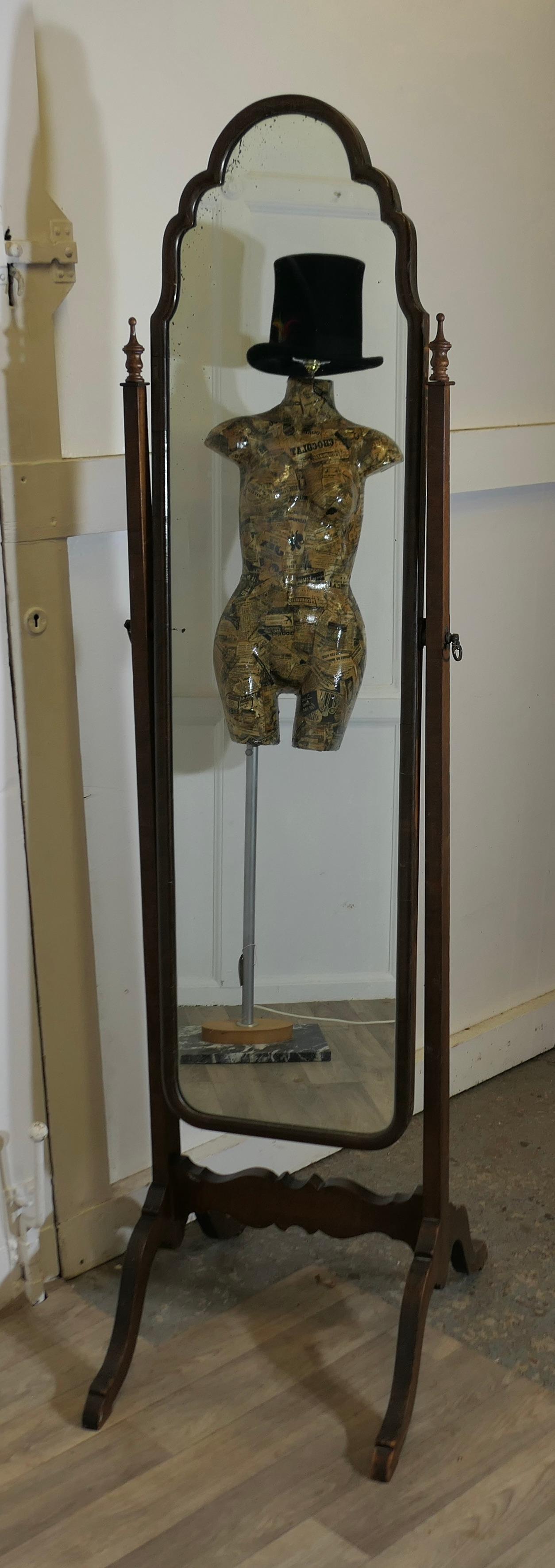 Stylish Edwardian Walnut Cheval Mirror

This fine quality Mirror has a Scalloped shaped top, it sits firmly in its stand and swivels for maximum advantage
The Stand has arching splayed feet with a pretty tretcher. 
Both the Stand and Mirror are in