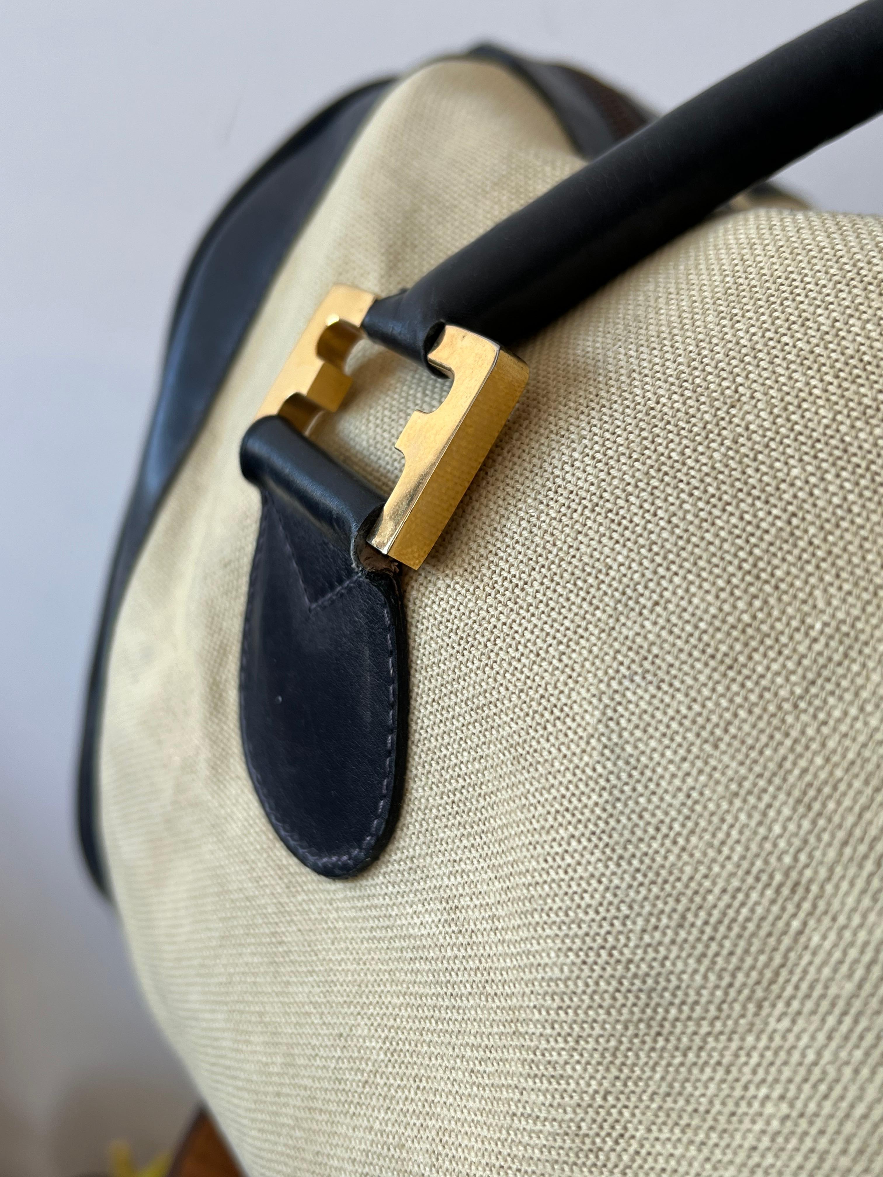 A stylish and perfect for the summer-duffle bag by Salvatore Ferragamo, Firenze, Italy.  Blue leather, canvas, opposing F brass insignia. 