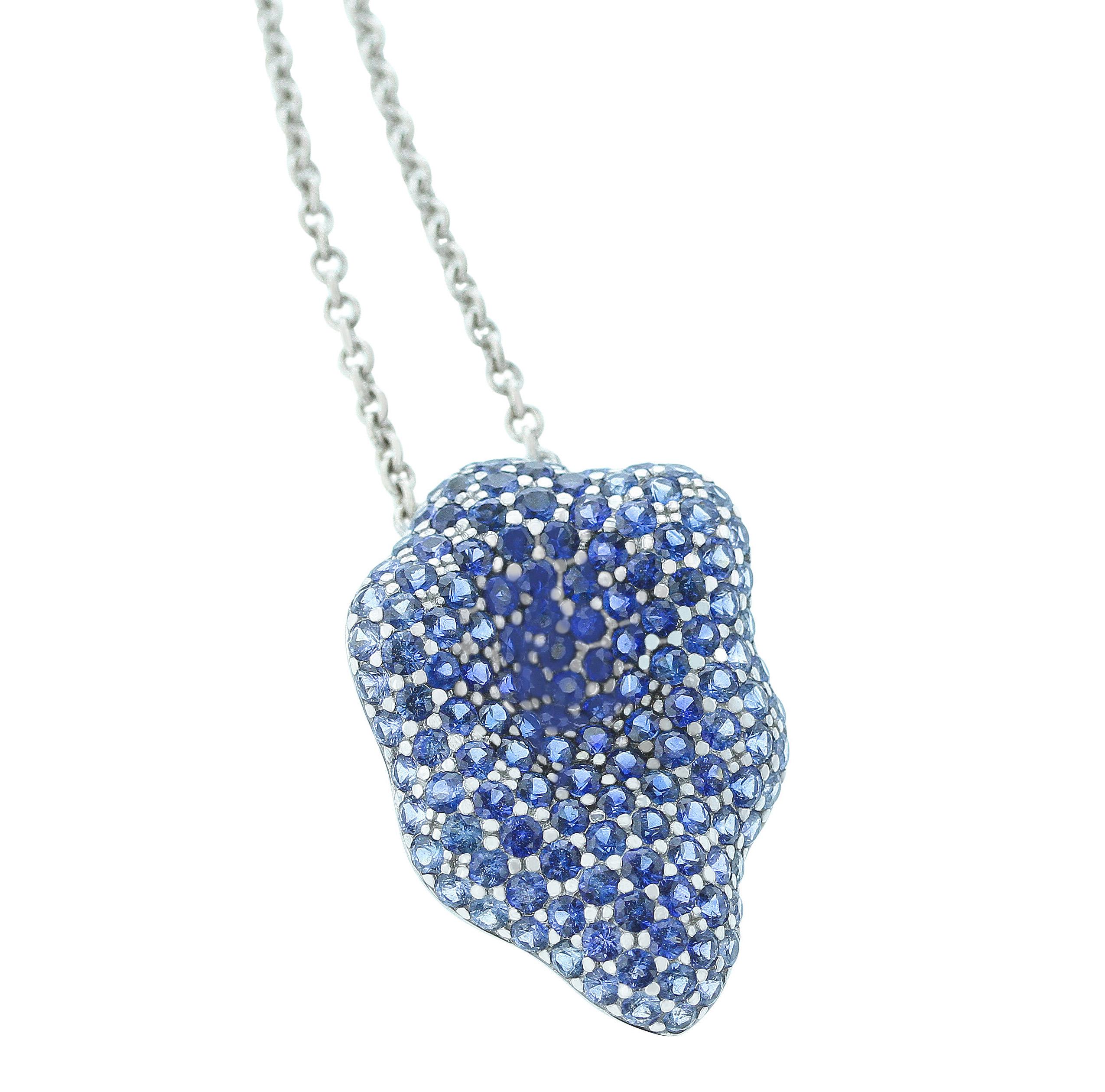 A stylish and bold floral pendant with blue sapphires. The pendant is curved from the center, giving the complete floral look, 18K White Gold. 18