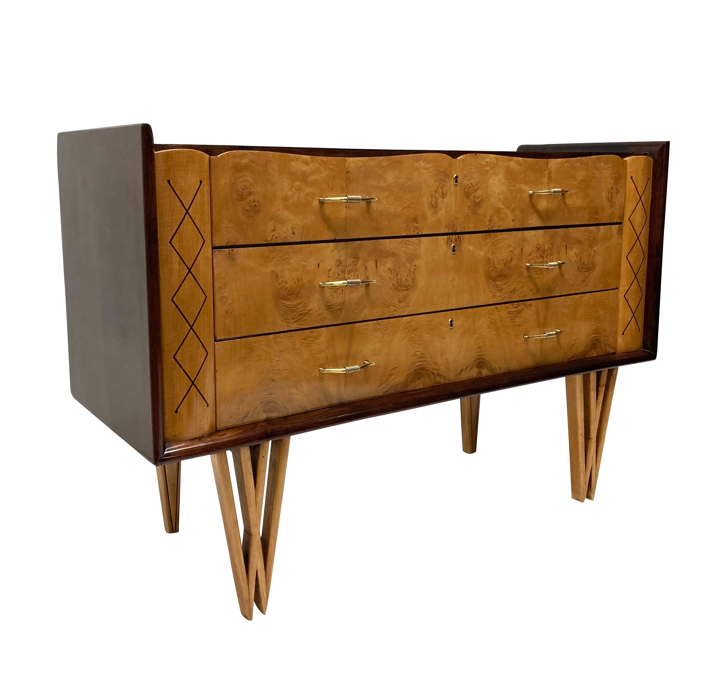 A stylish French mid-century commode of unusual design. With three drawers in walnut, each with elegant brass handles. The commode sits on double 'v' shaped front legs in fruitwood and the drawers each flanked by a hand painted design.