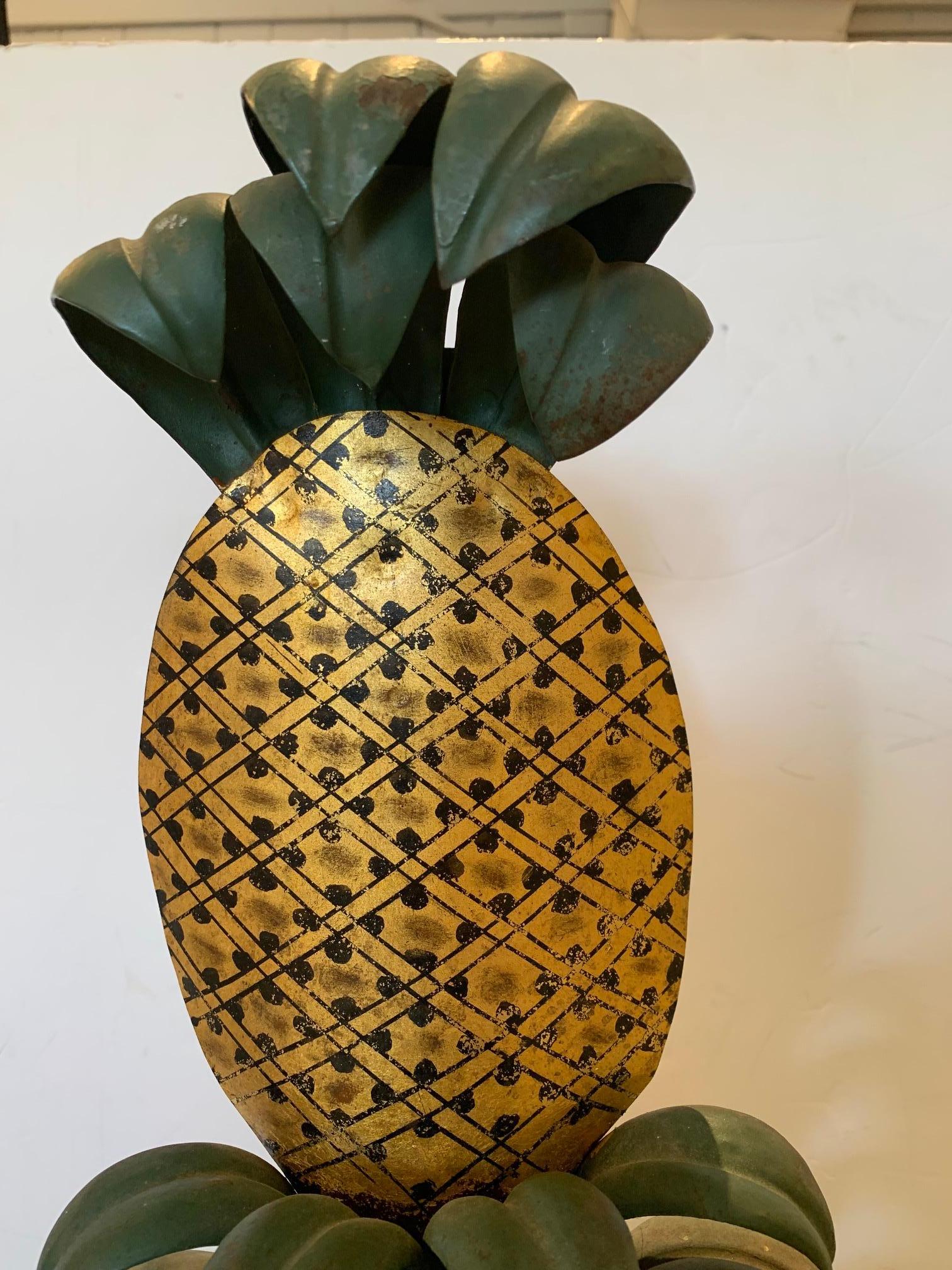 French tole and iron painted and gilded hanging wall sculpture of a neoclassical pineapple.