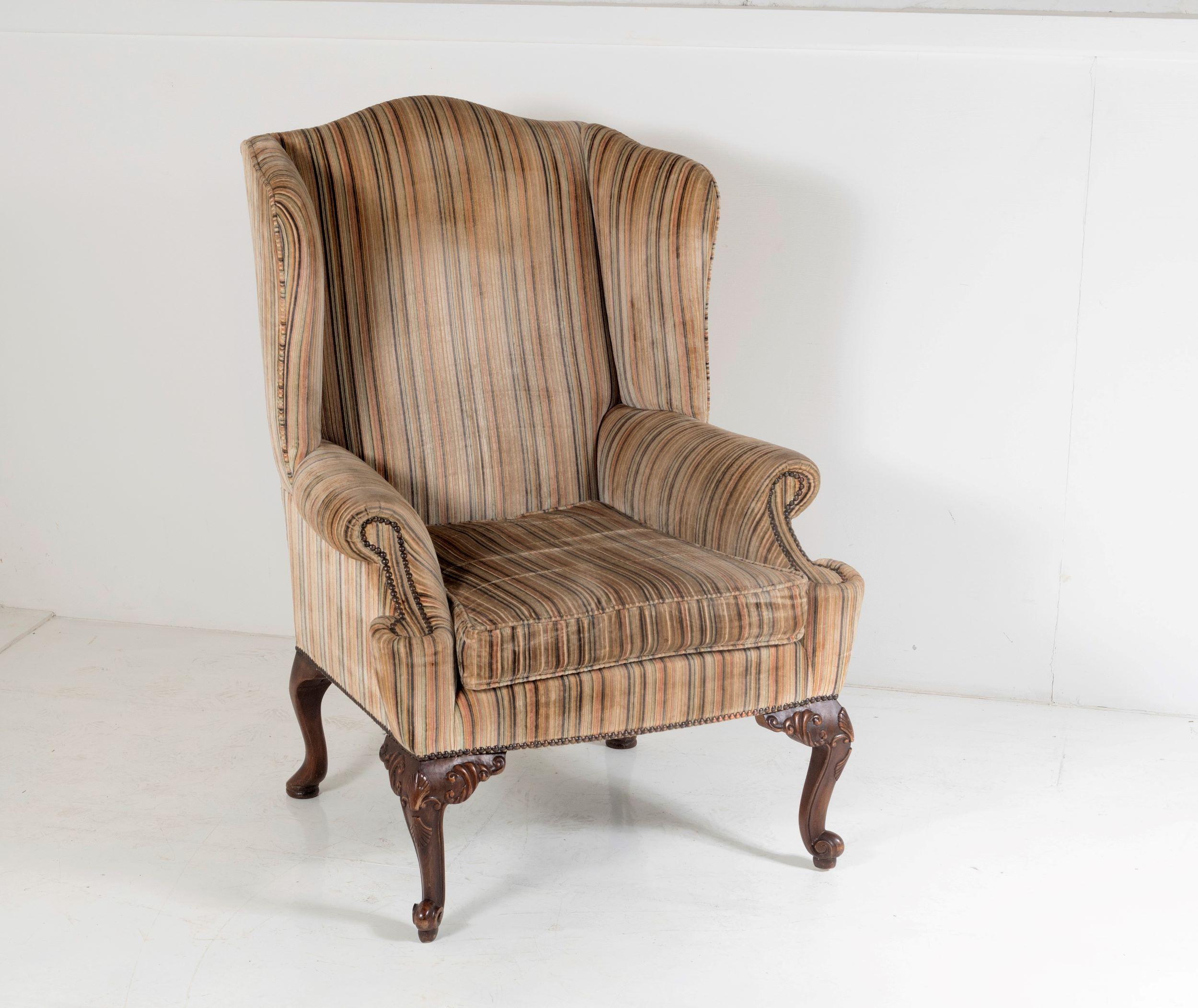A good quality George III style wing back armchair with original striped upholstery on short cabriole legs and pad feet.
The upholstery is in good order, some fading but overall in very good condition with nice pile, a stylish striped upholstery
