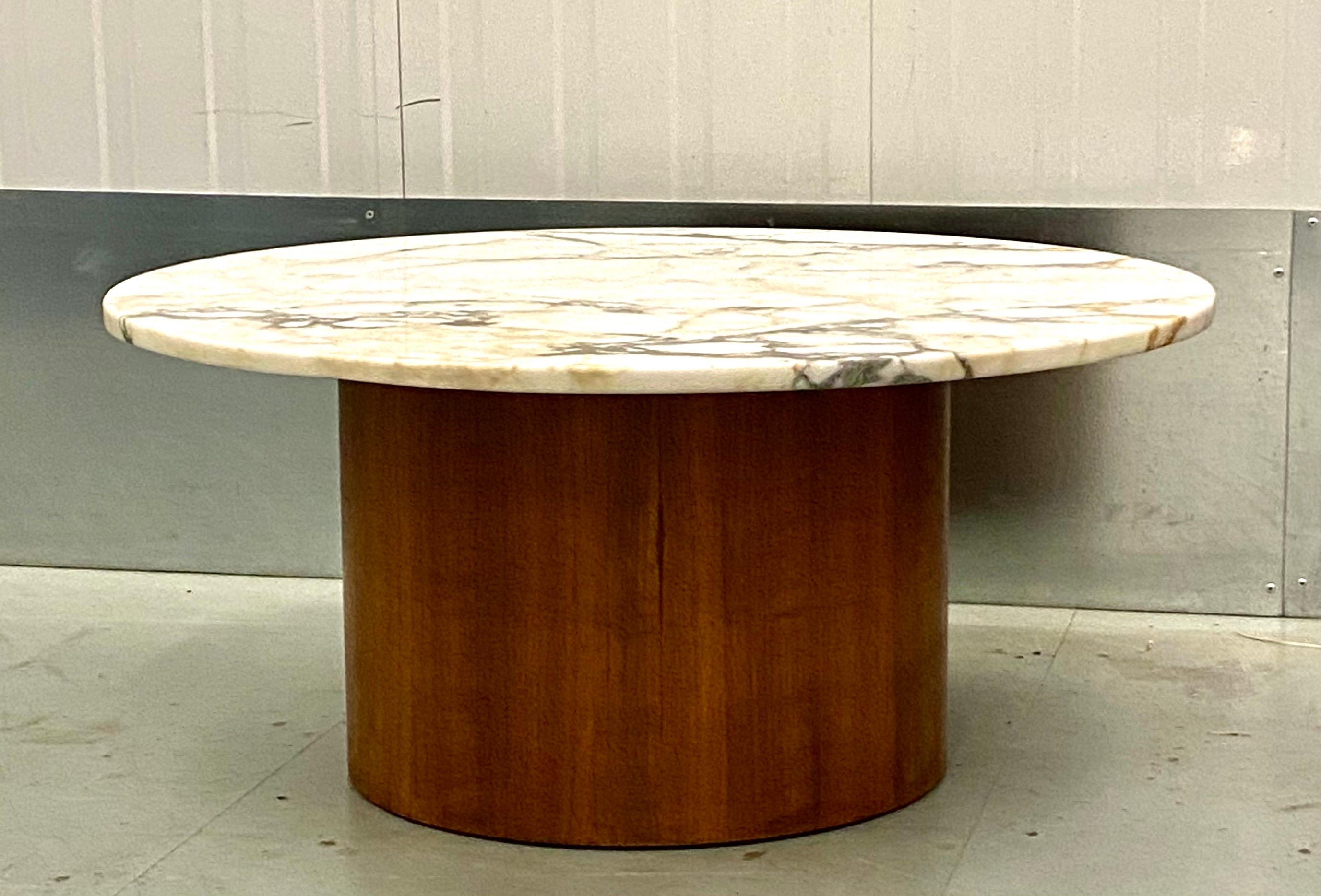 Stylish Mid-Century Modern teak & marble top round coffee table Circa 1970's.
The base is a well streaky grained teak wood that is very solid. A robust table base that is sturdy
enough to accommodate the heavy 1.4 inch thick round marble top. This