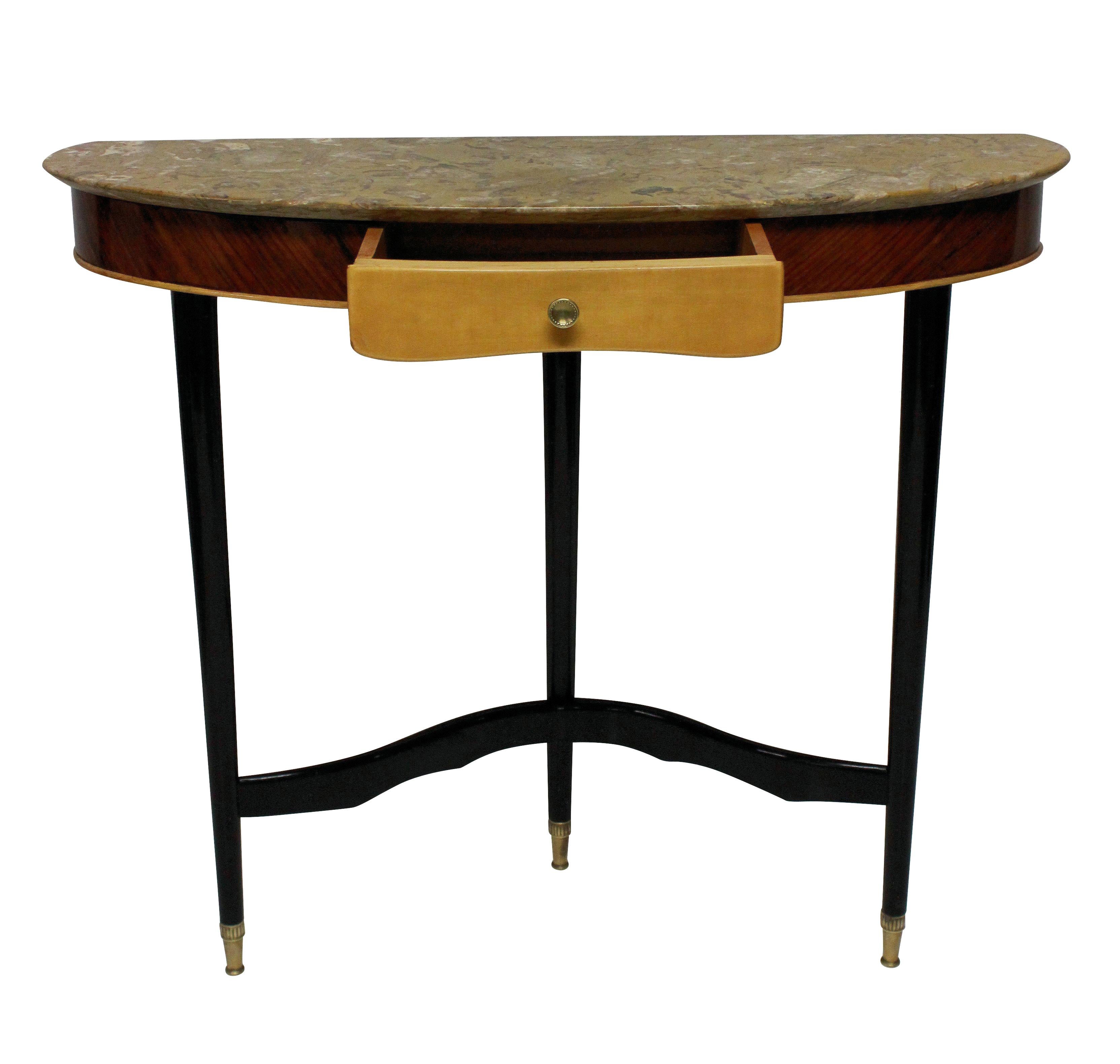 An Italian console table of stylish design, with two tone wood, ebonized legs, brass fittings and a fossil marble top.

 
