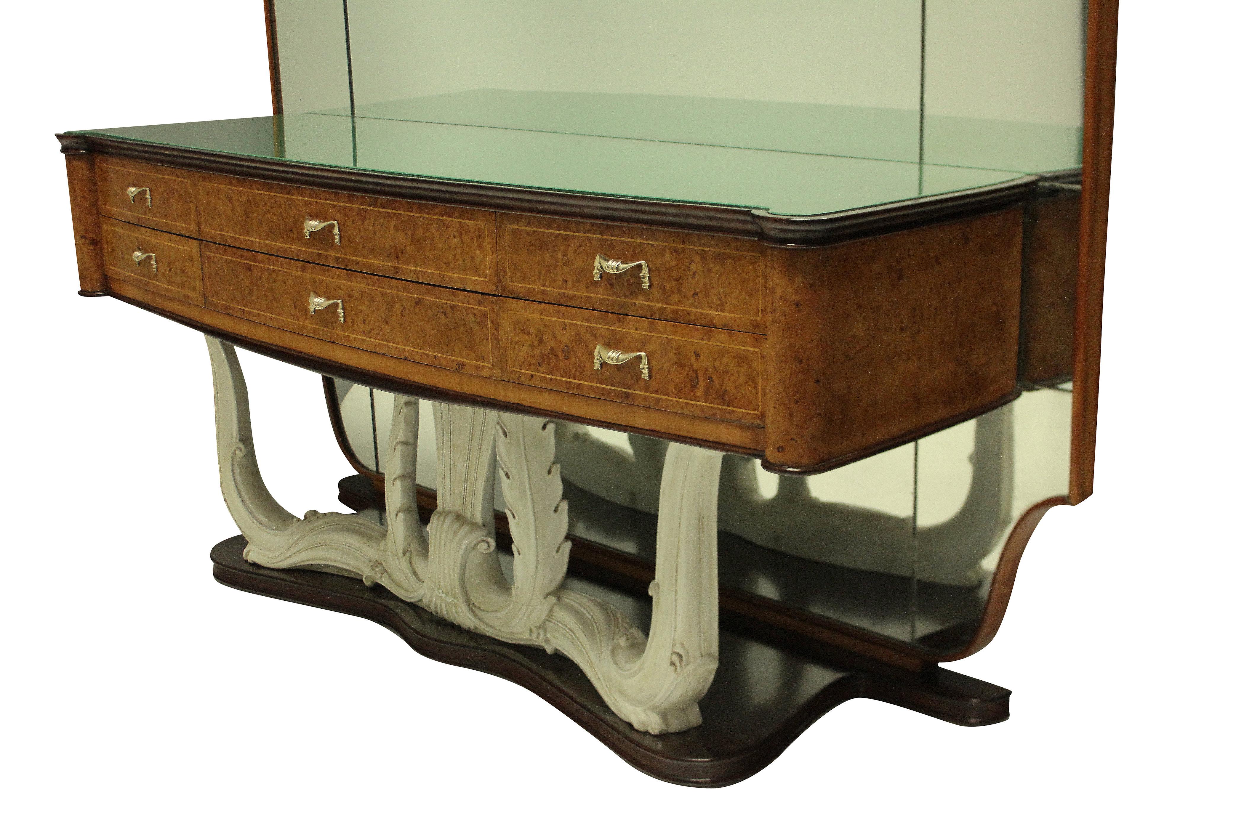 A stylish Italian mid-century hall console with full length mirror with sconces. The console with six drawers in walnut root, with brass handles, a carved faux ivory base and it's original green glass inset top. The mirror is framed in walnut and