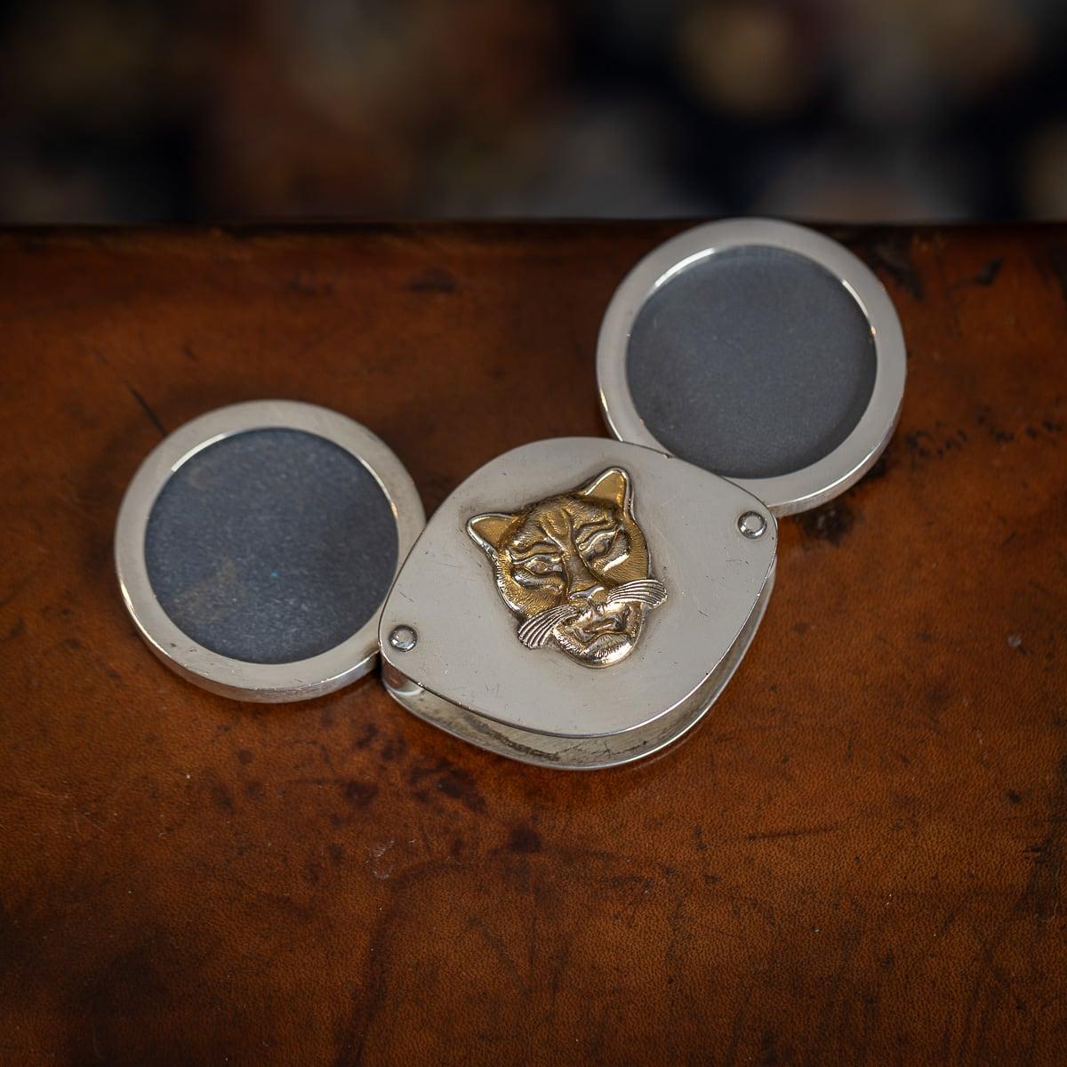 Stylish solid silver photograph frame in the shape of a lozenge with retractable circular photo frames, set with a gilded jaguar mask. Hallmarked English silver (925 standard), London, year 2002 (C), Maker GGM (Grant MacDonald Silversmiths - George