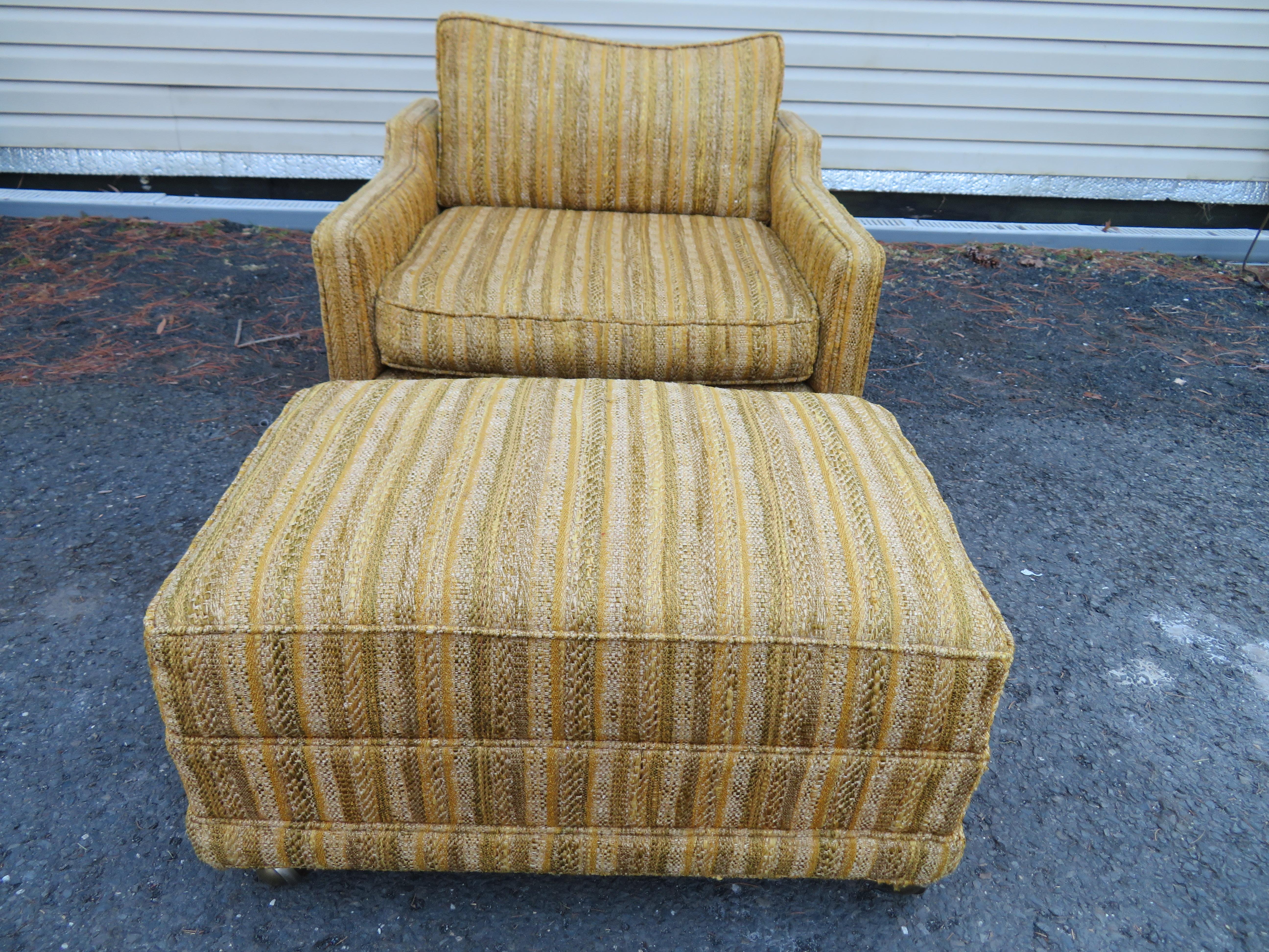 Stylish John Widdicomb rolling lounge chair and ottoman. This chair is beyond comfortable with a down-filled back cushion and original matching ottoman. Both the chair and ottoman have casters making this set easy to move around. The chair measures