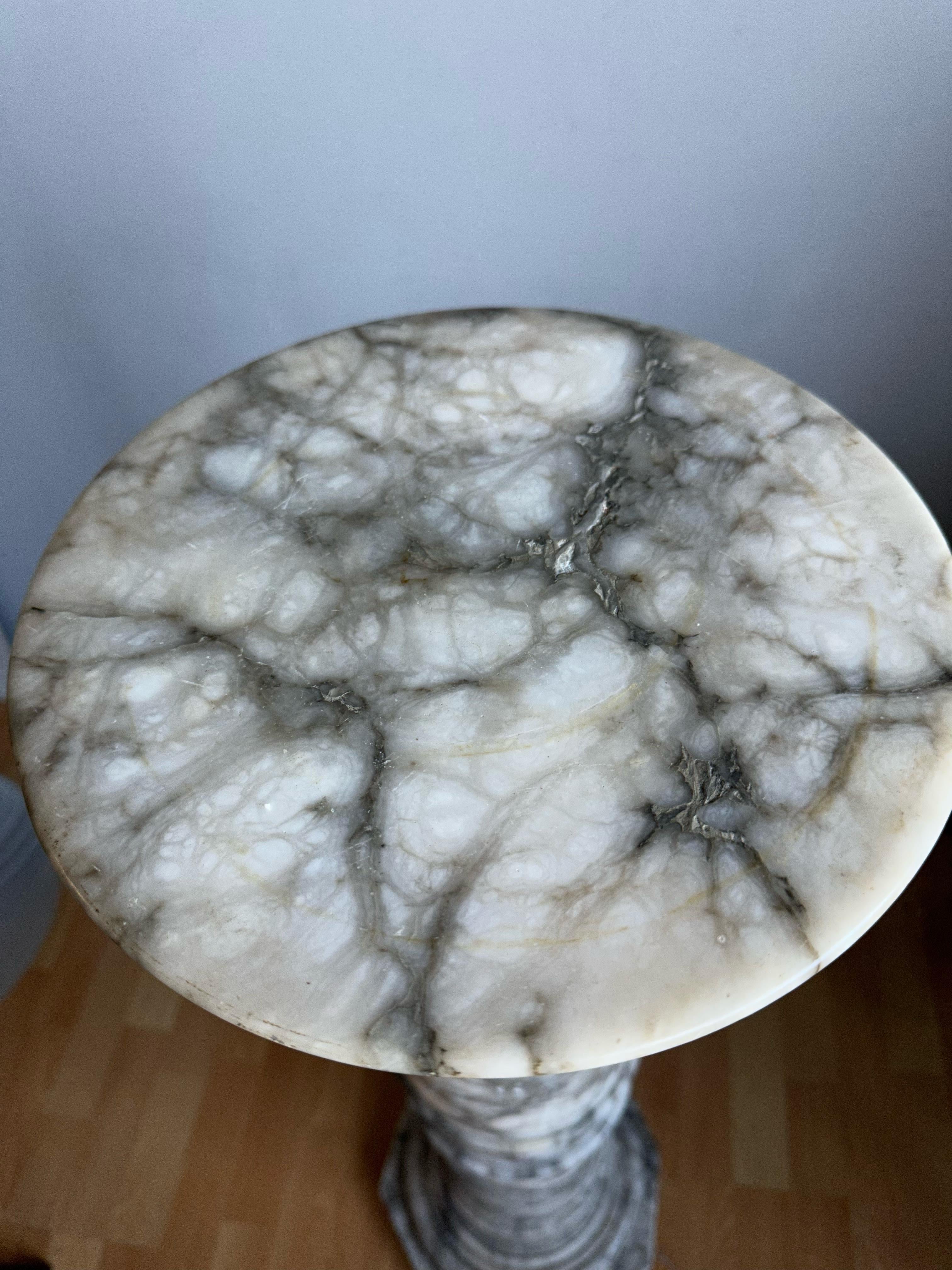 Wonderful Roman column for displaying a work of art.

This antique, beautiful and classical pedestal is perfect for showcasing an antique sculpture or bust. The slight wear, the shape and the wonderful, grey veins in the beige-white alabaster give