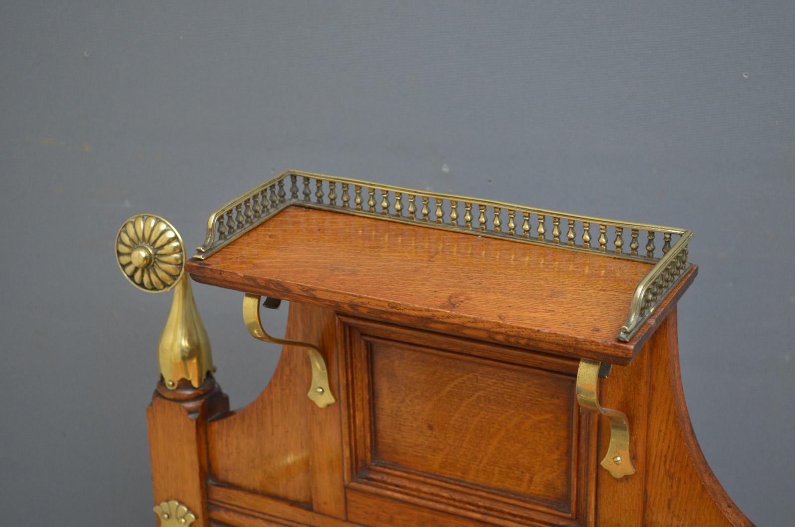 Sn4444 stylish late Victorian umbrella stand in the manner of James Schoolbred, having brass gallery to the shelf over moulded recessed panels and turned columns all fitted with decorative brasses and original drip tray, all in excellent original