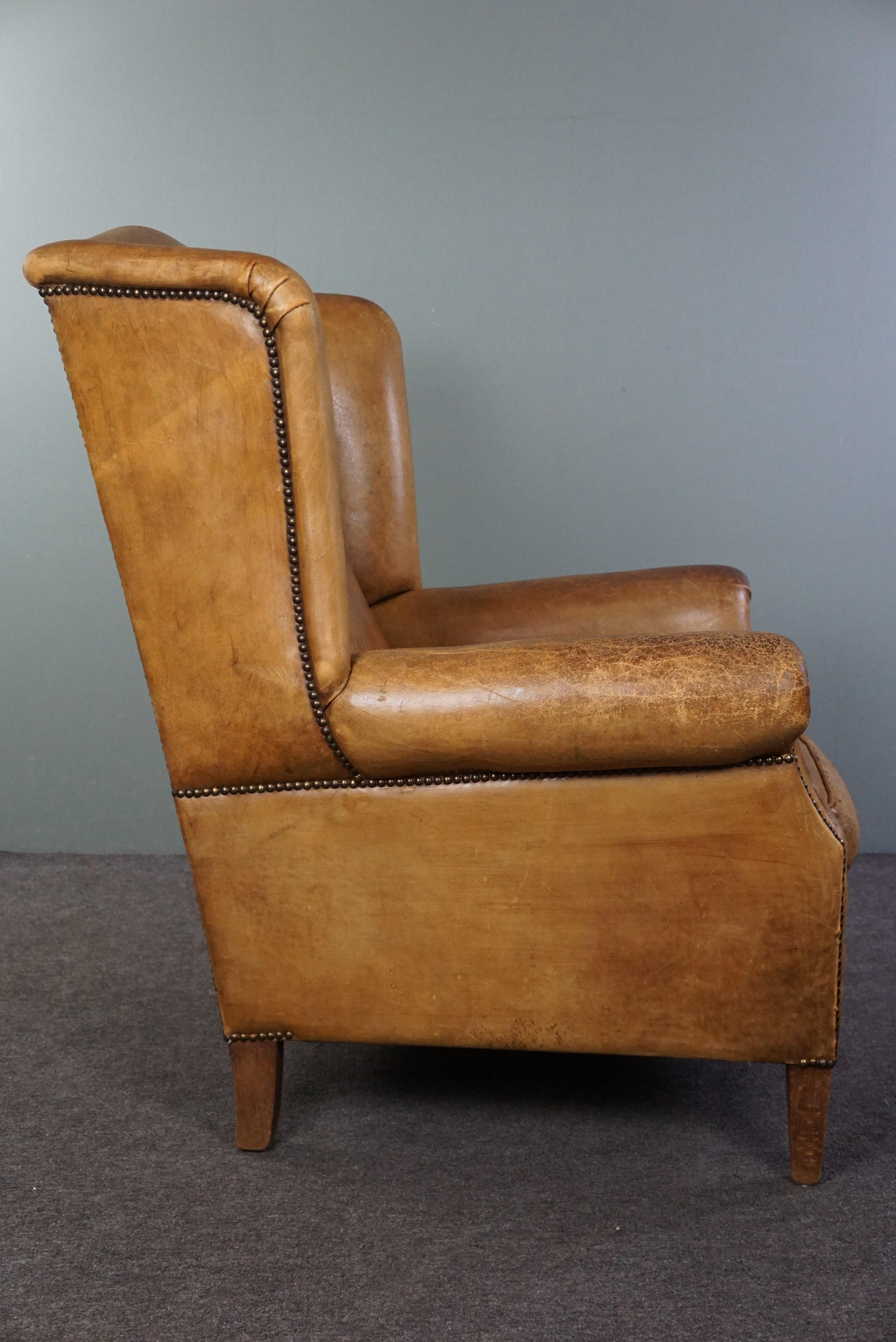 Stylish, lived-in light-colored sheepskin wingback chair In Good Condition For Sale In Harderwijk, NL