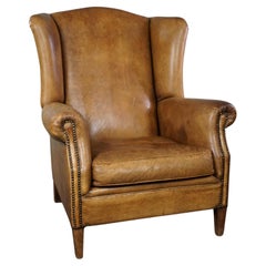 Stylish, lived-in light-colored sheepskin wingback chair