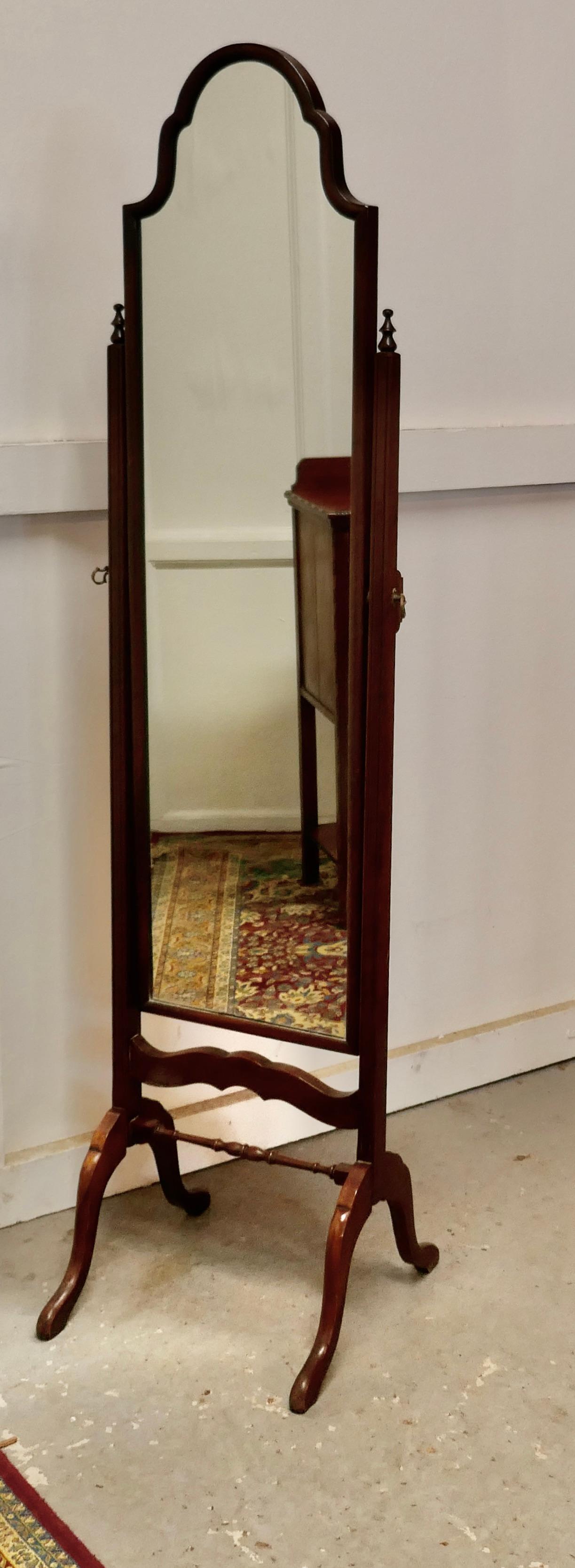 Stylish mahogany reprodux cheval mirror by Bevan & Funnell

This fine quality mirror has a Scalloped shaped top, it sits firmly in its stand and swivels for maximum advantage
The Mahogany stand has arching splayed feet with a pretty turned