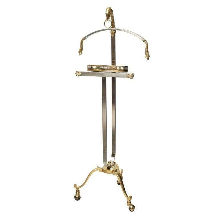 Stylish and elegant Maison Jansen steel and brass gentleman valet, made in Italy.
Maison Jansen (French, founded 1880) Ram's head valet, circa 1960. 
Elegant masculine brushed stainless steel and brass valet with cast ram's heads with classic hoof