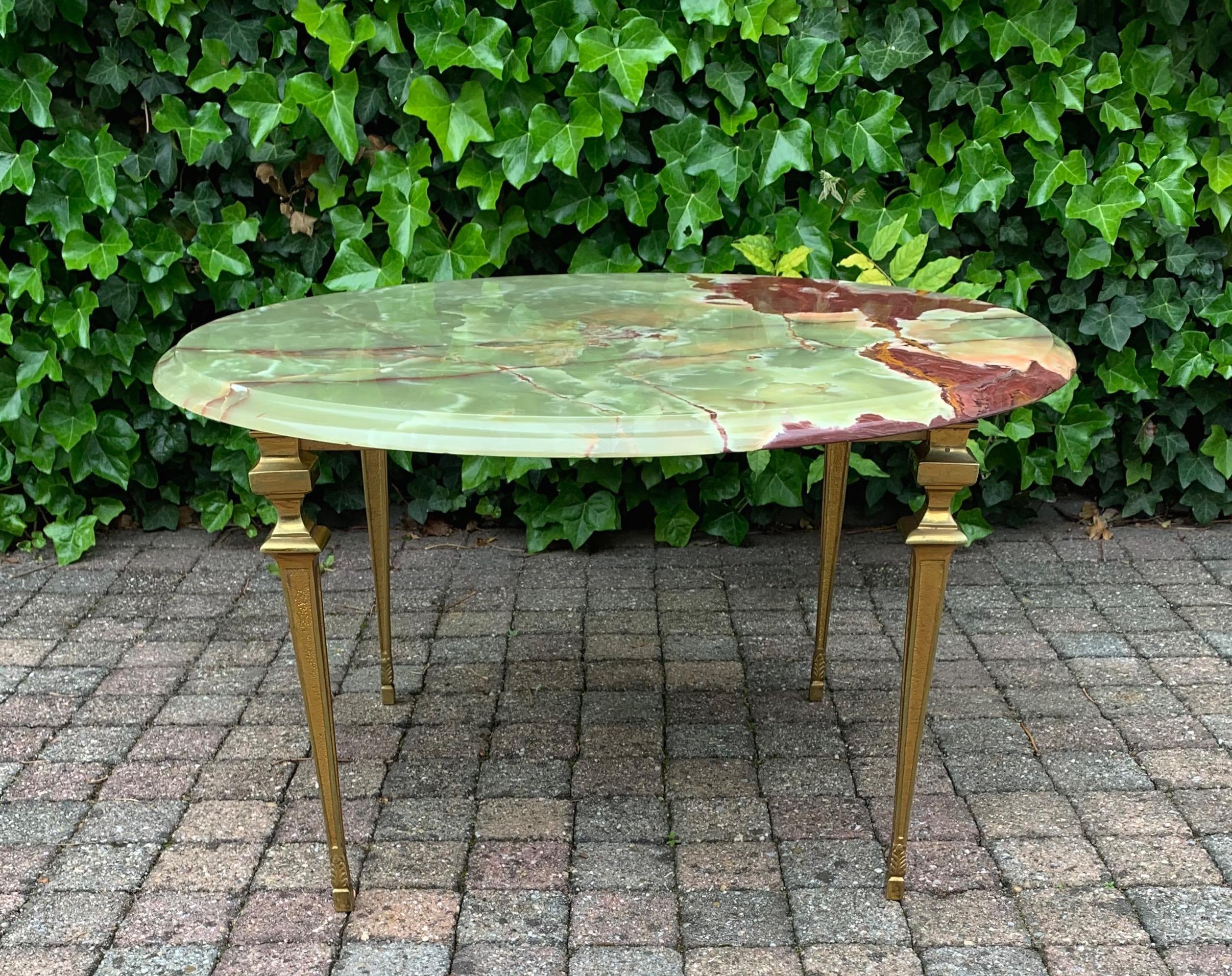 Wonderfully made and great looking table. 

This classical design coffee table will look perfect in a classical, in a Hollywood Regency, but also in some contemporary interiors. The slight wear to the bronze base, the overal shape and the wonderful