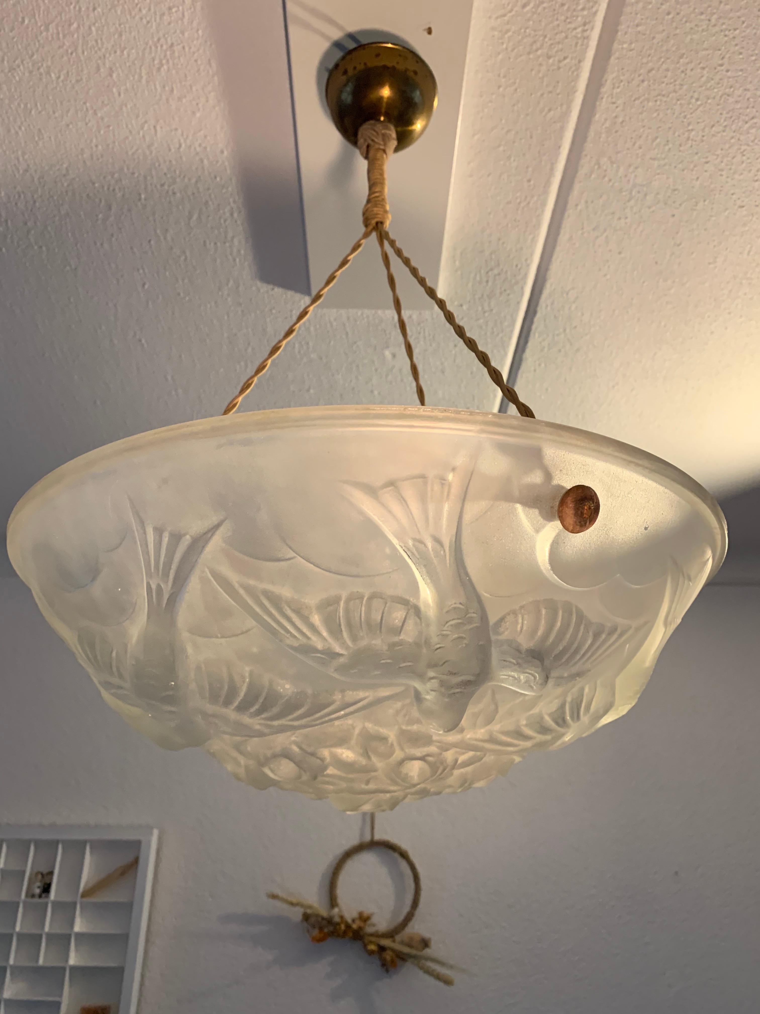 Impressive Art Deco pendant light by Verart with dove sculptures in relief.

This early 20th century, French Art Deco light fixture is another great example of the stylish and meaningful pieces that the French were creating in the 1920s. It is