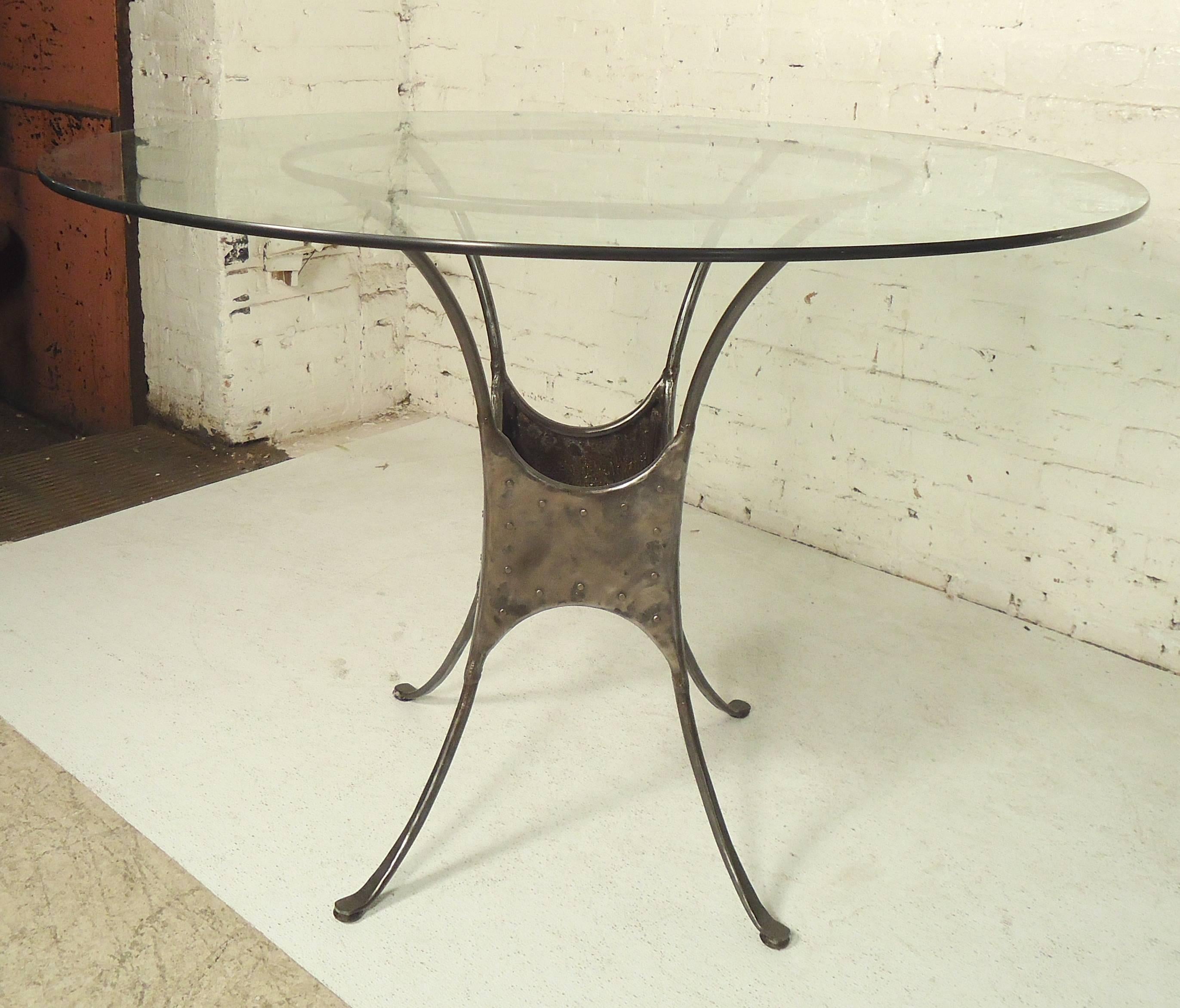 Round glass top dining table with industrial metal base. Metal has been stripped and given a bare metal style finish.

(Please confirm item location NY or NJ with dealer).
 