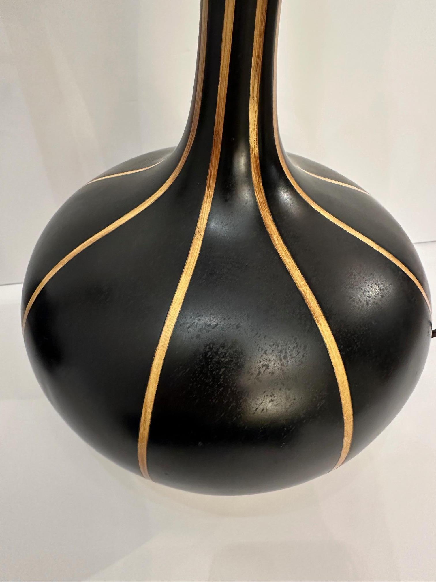 Stylish pair of sculptural black and brown striped mid century modern table lamps having sensual shape on steel bases.
31.75” H to finial
10” Diameter
Shade 15” W x 10.5” H 10”D