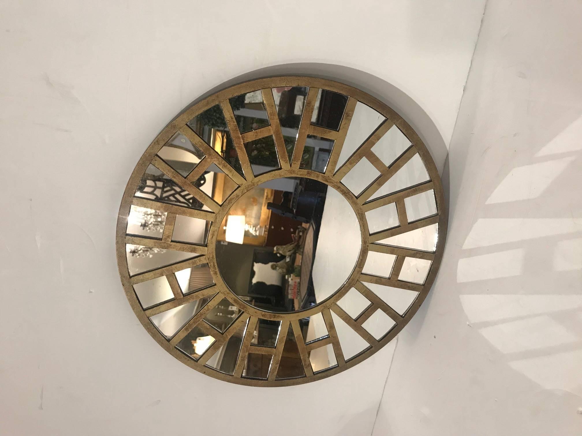 Mid-Century Modern small round mirror with large burst of style, having a wood composition gilded overlay that looks like the letter H strung together.
Centre mirror 6.5 inches diameter.