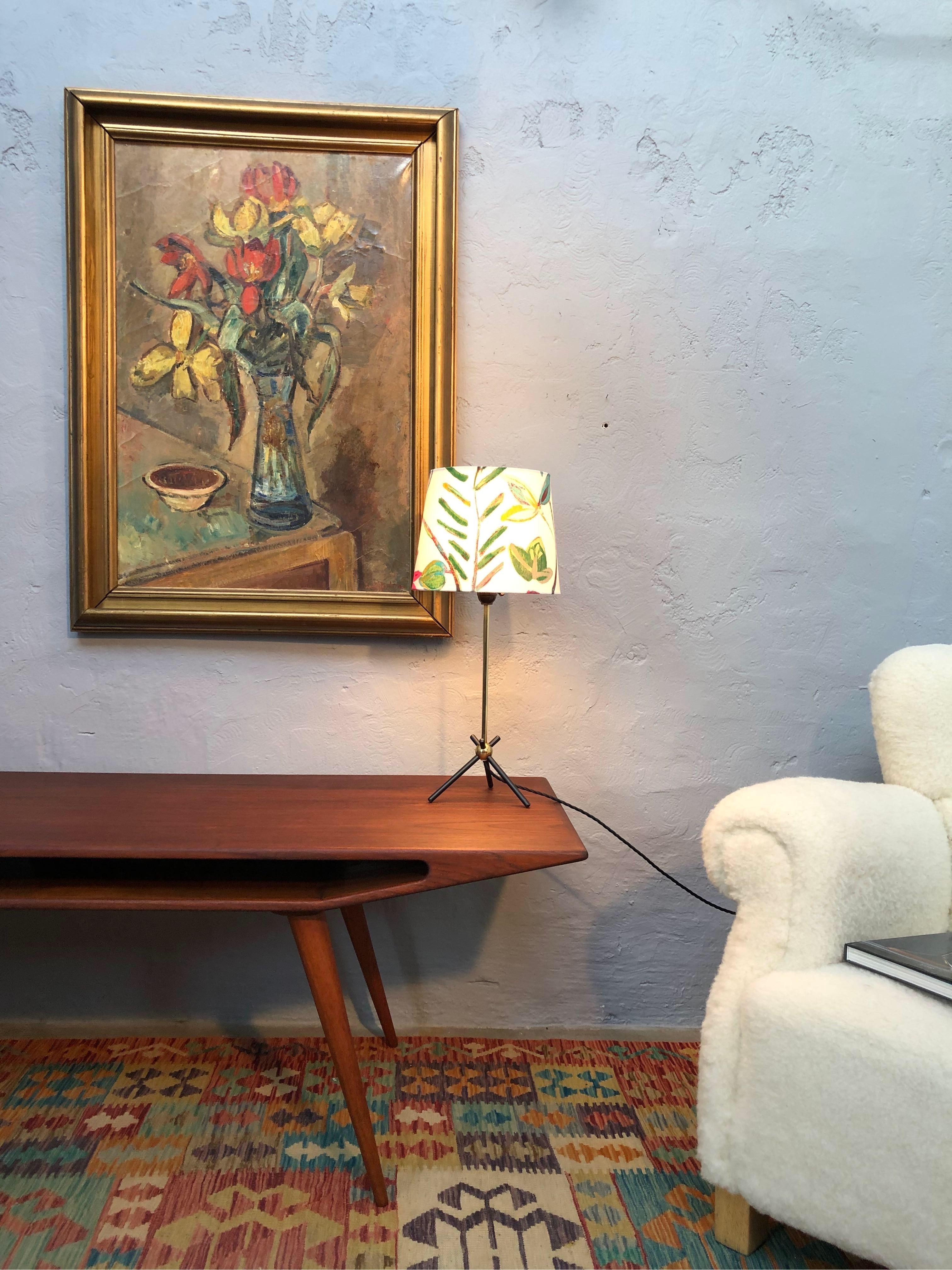 Vintage Mid-Century Modern table lamp with a very stylish period design.
Three legged steel base attached to a brass stem.
Rewired with a black twisted cloth flex and grounded.
Original Bakelite lamp holder with on off switch.
In house made