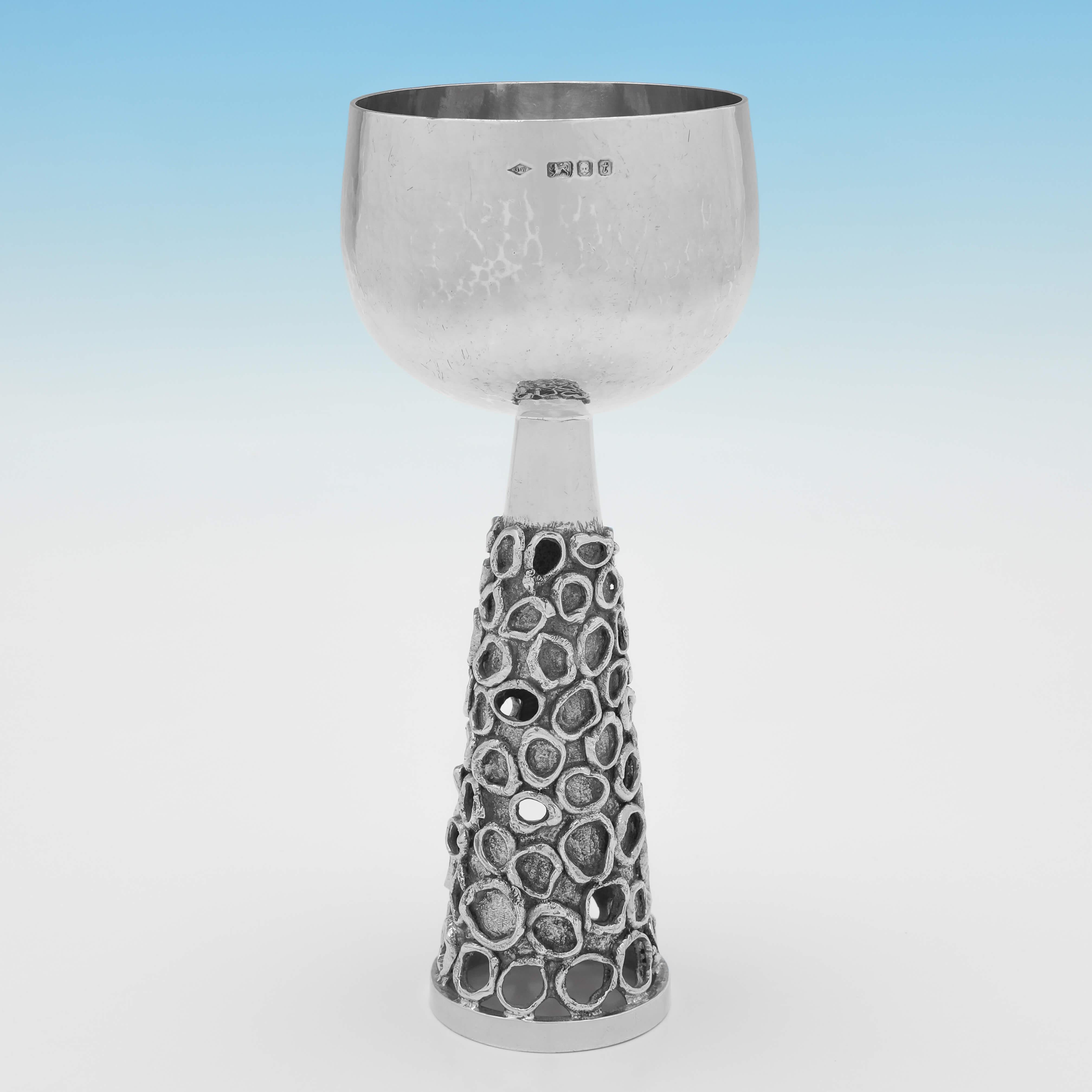 This very stylish set of 8 sterling silver wine goblets were hallmarked in London in 1974 by Graham Watling. 

The goblets are a fine example of the handcrafted and hand raised silverware that Graham was known for, and they would have formed an
