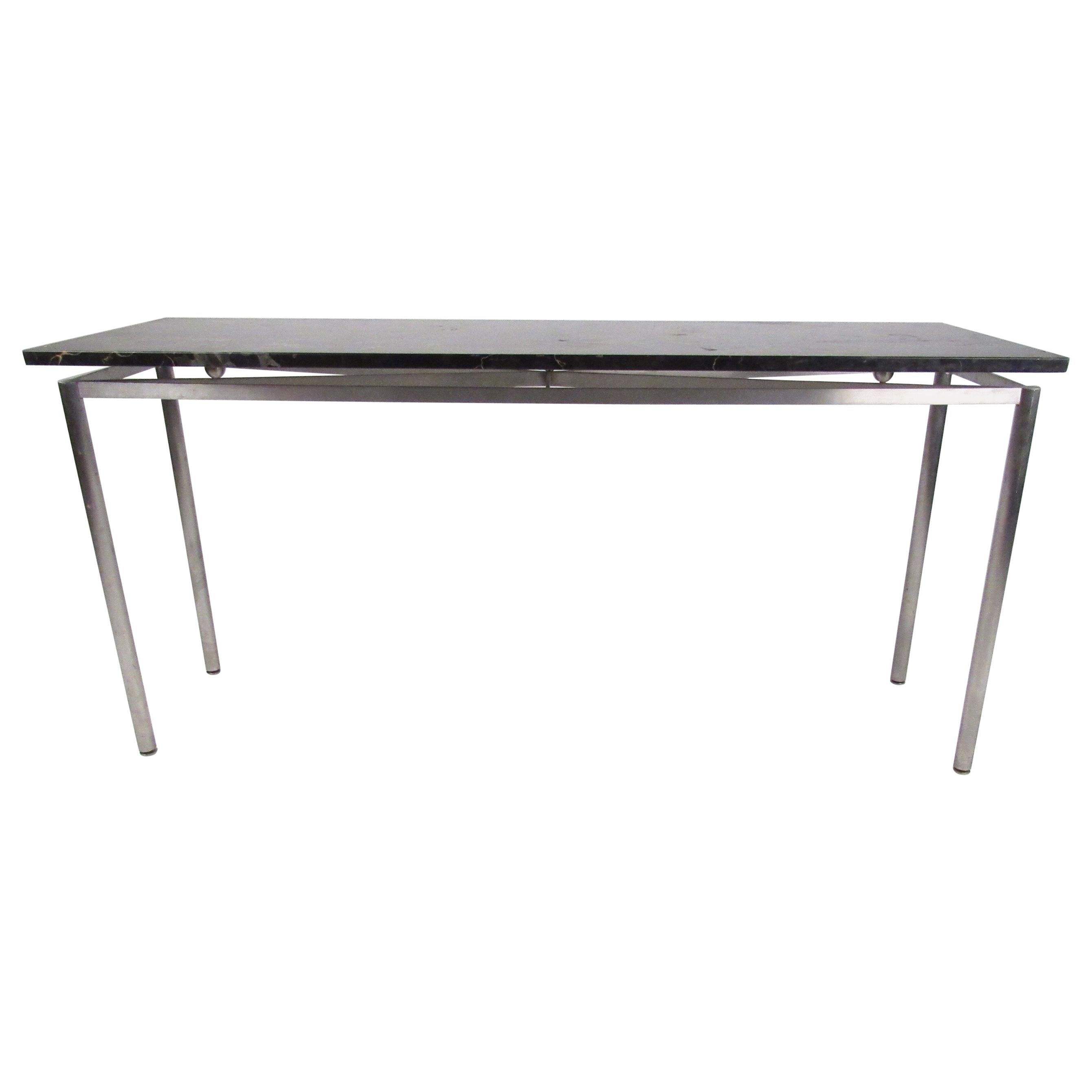 La console contemporanea e moderna è caratterizzata da un piano in marmo fluttuante e da un'esclusiva struttura in metallo. Questo pezzo, di altezza perfetta per un divano o un tavolo da ingresso, è un'elegante dichiarazione di modernità in casa o