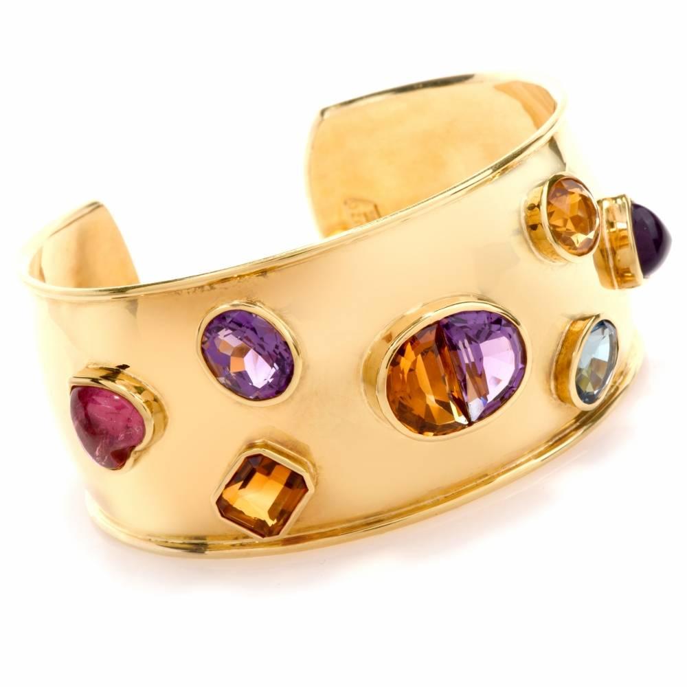 This stylish cuff bracelet crafted in 18-Karat yellow gold weighs 45.4 grams and measures 7 inches around the wrist and 1.3 inch wide. Designed as an open-end cuff bracelet, it is enriched with a half-moon amethyst and citrine as well as an