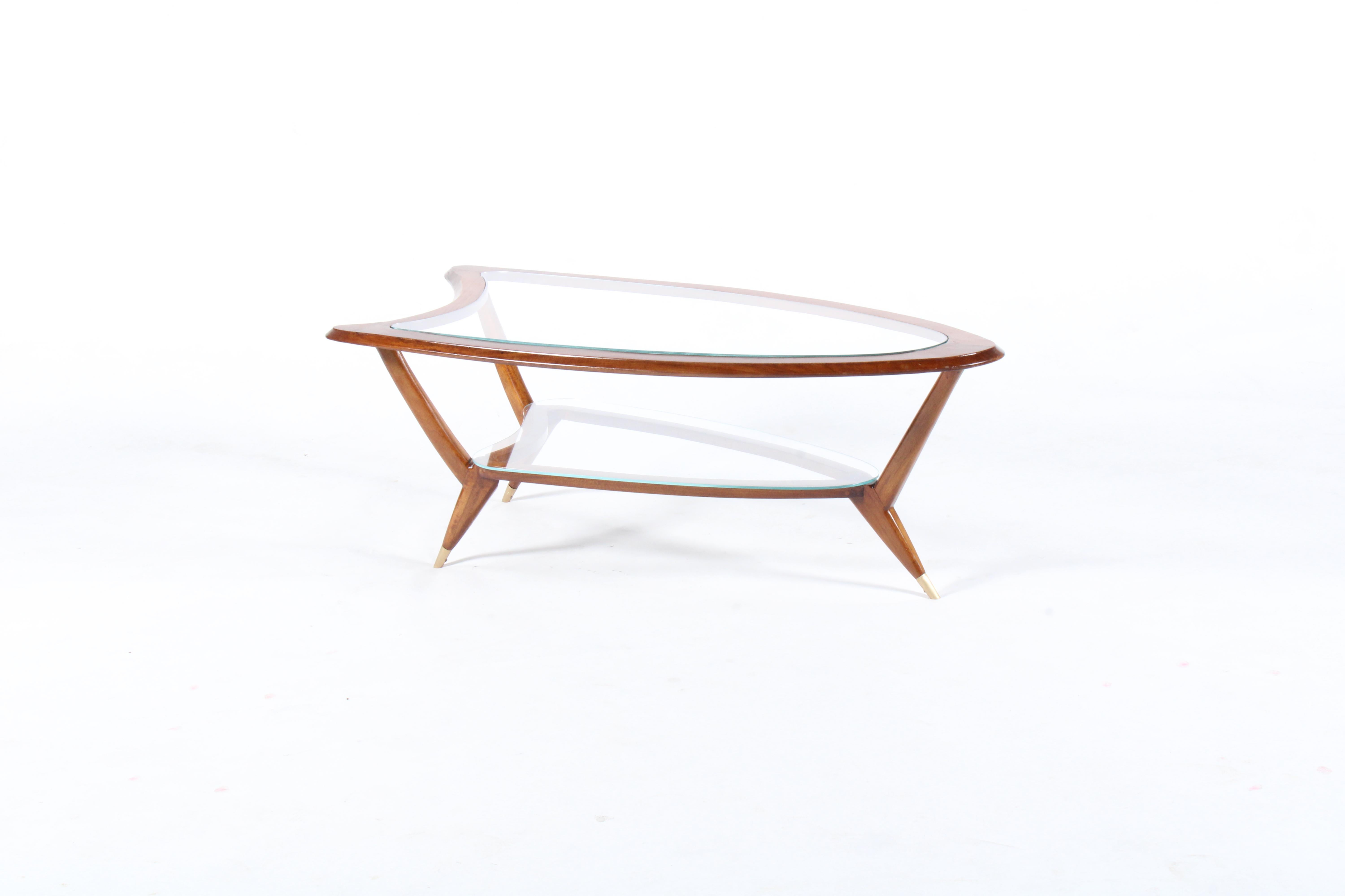 Stylish original mid century Italian coffee table in Santos Mahogany with inset glass top and shelf. This beautiful piece with soft curving lines and tapered legs with brass toe detailing is of pure mid century Italian design form and as well as