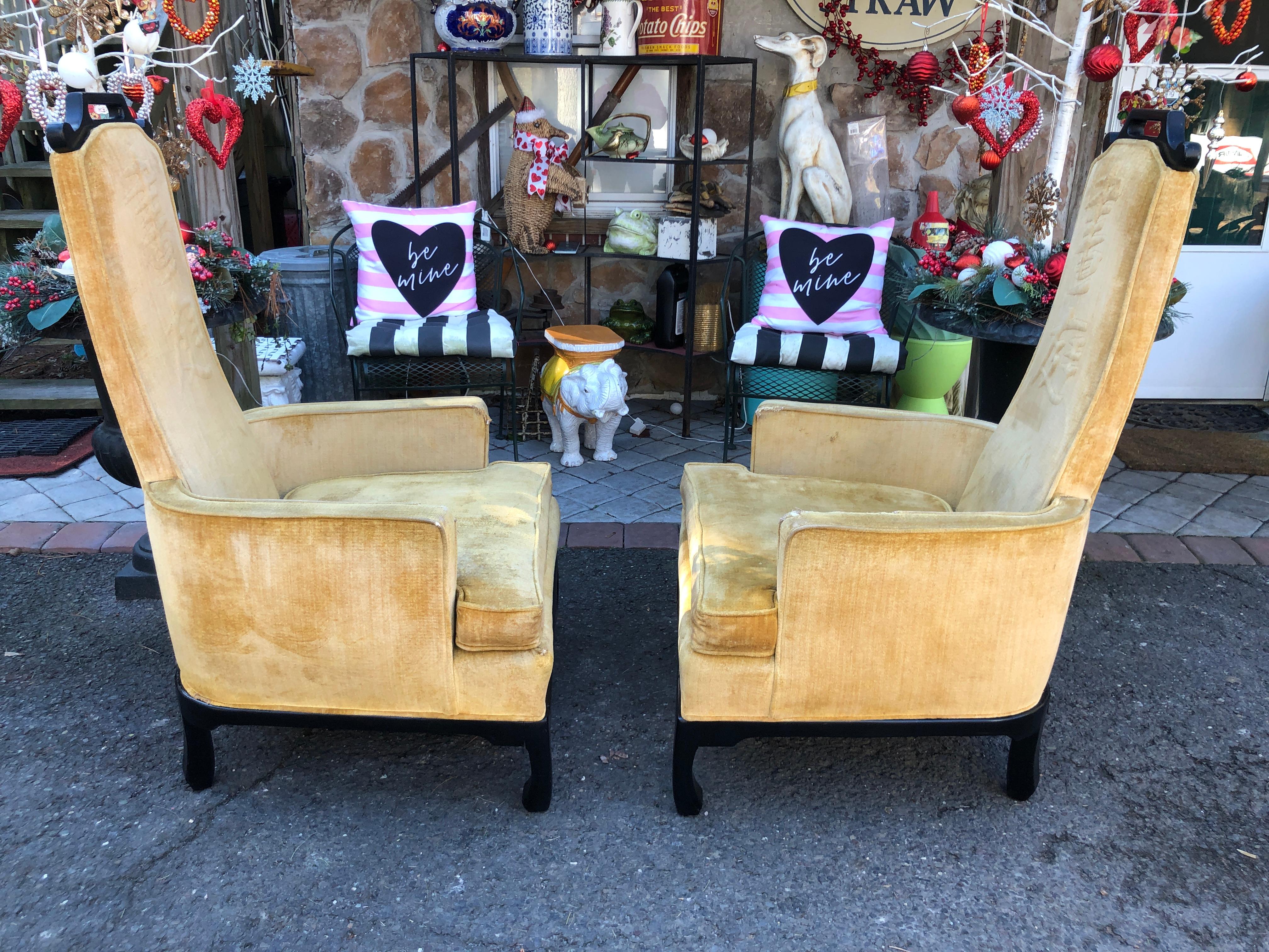 Stylish pair 1950’s armchairs by Norman Fox MacGregor in an Oriental Hollywood Regency over the top style.  A fun exaggerated form with high backs and bowed, ebonized bases. The upholstery shows wear but frames are ready for your clients favorite
