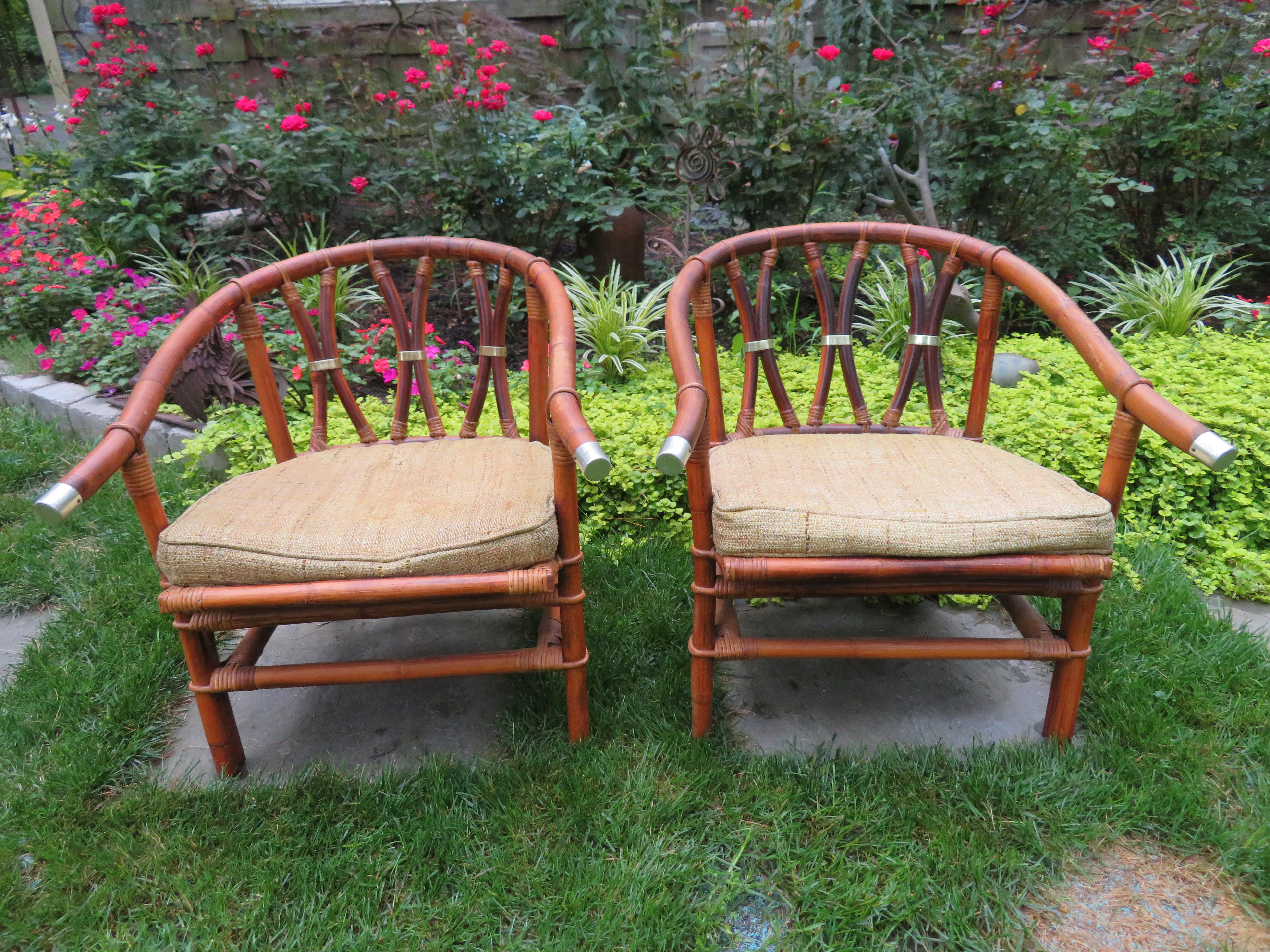 Stylish pair of John Wisner Far Horizon horseshoe back rattan chairs with matching ottoman. John Wisner graduated from Parsons School Of Design in 1935 and designed for both private clients, and corporate clients including Dorothy Draper and Ficks