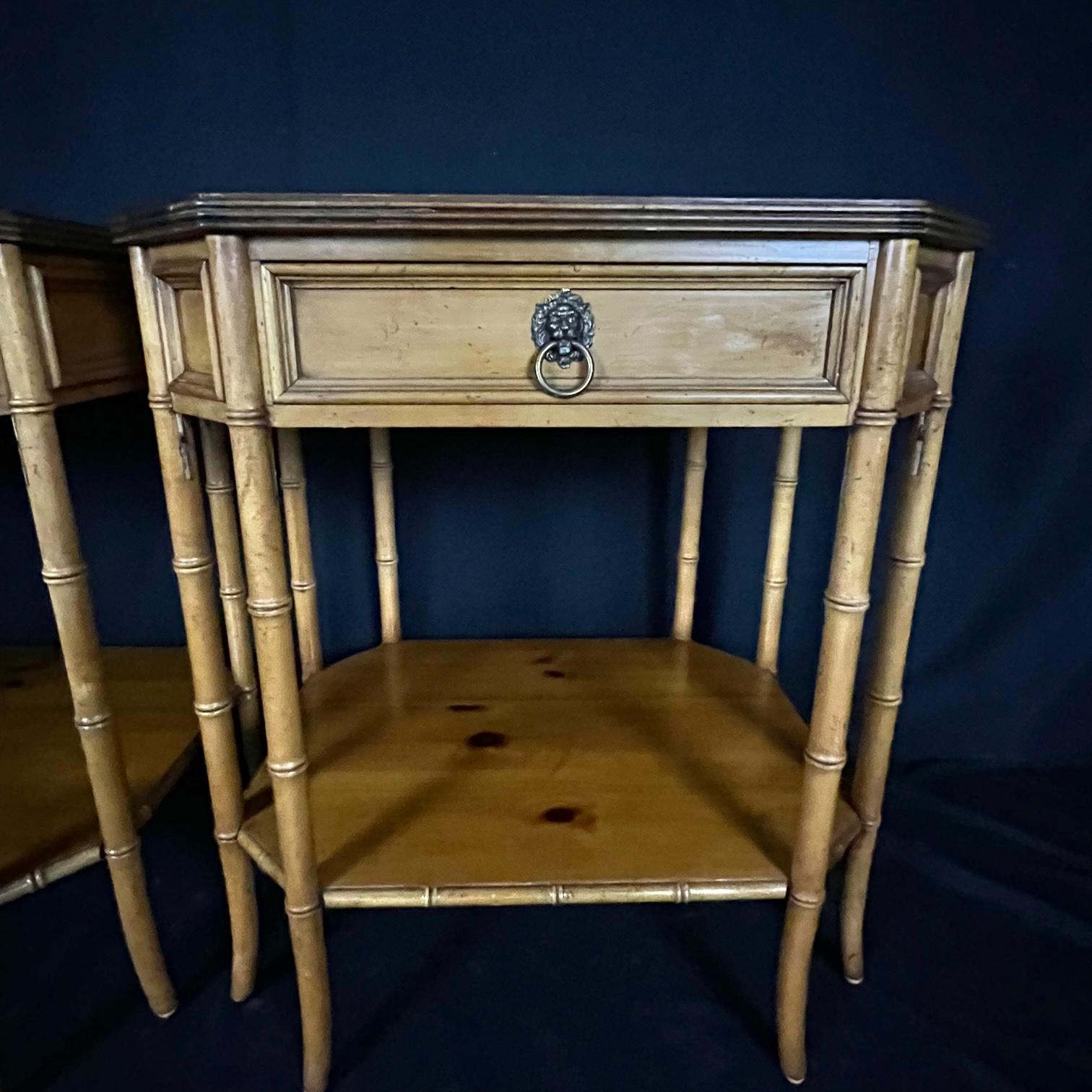 Outstanding faux bamboo side tables or night stands in maple and pine by Baker Furniture Co. Exceptional design and construction are the trademarks of Baker furniture. Finely detailed bamboo style legs are accented by the single drawer with lion